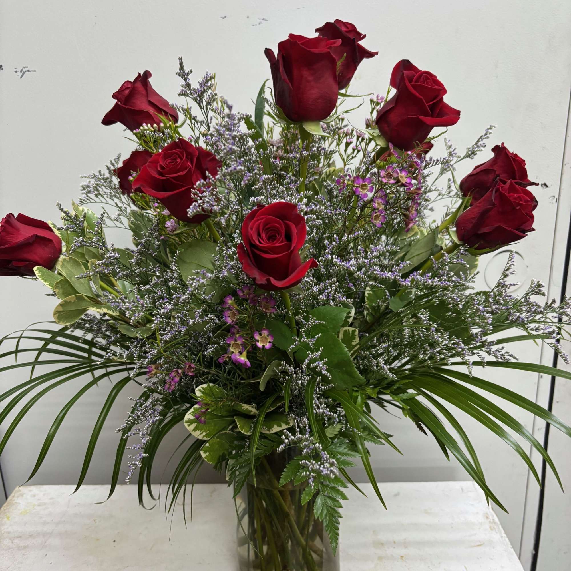 A charming bouquet of a dozen fresh and fragrant red roses, adorned