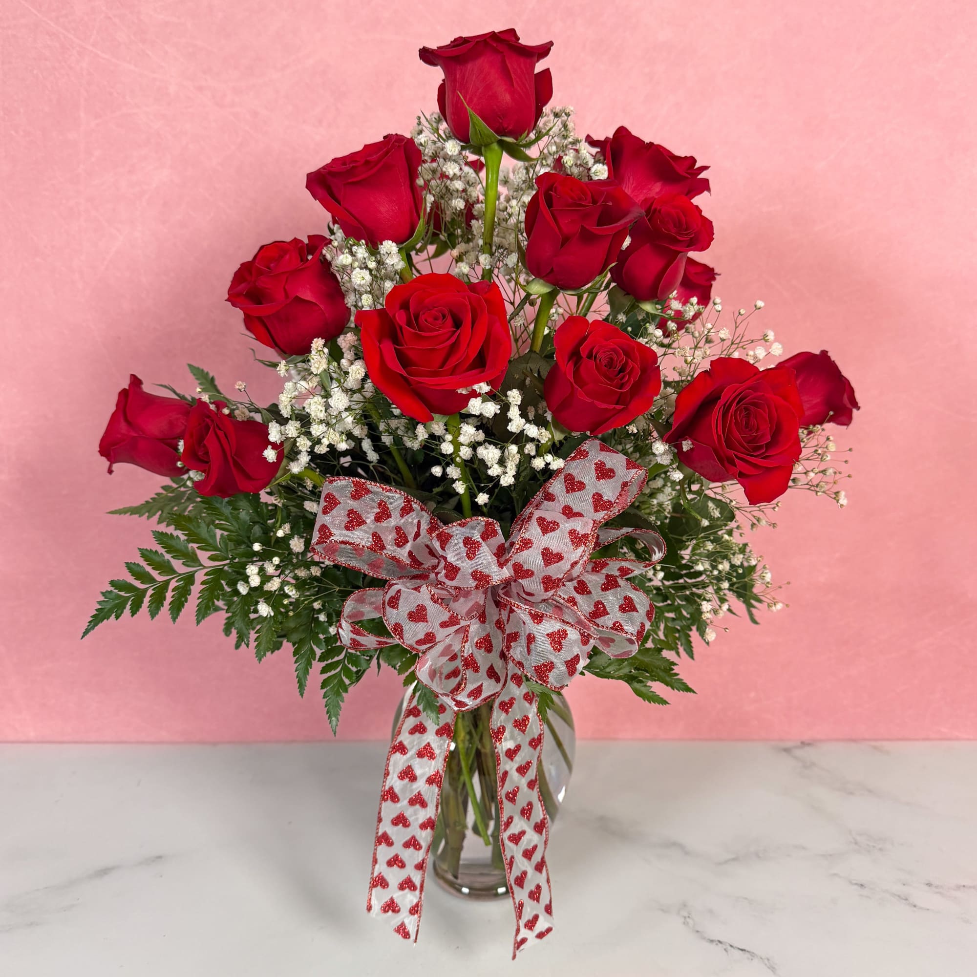 The Classic rendition of One Dozen Red Roses Vased by Savilles Florist
