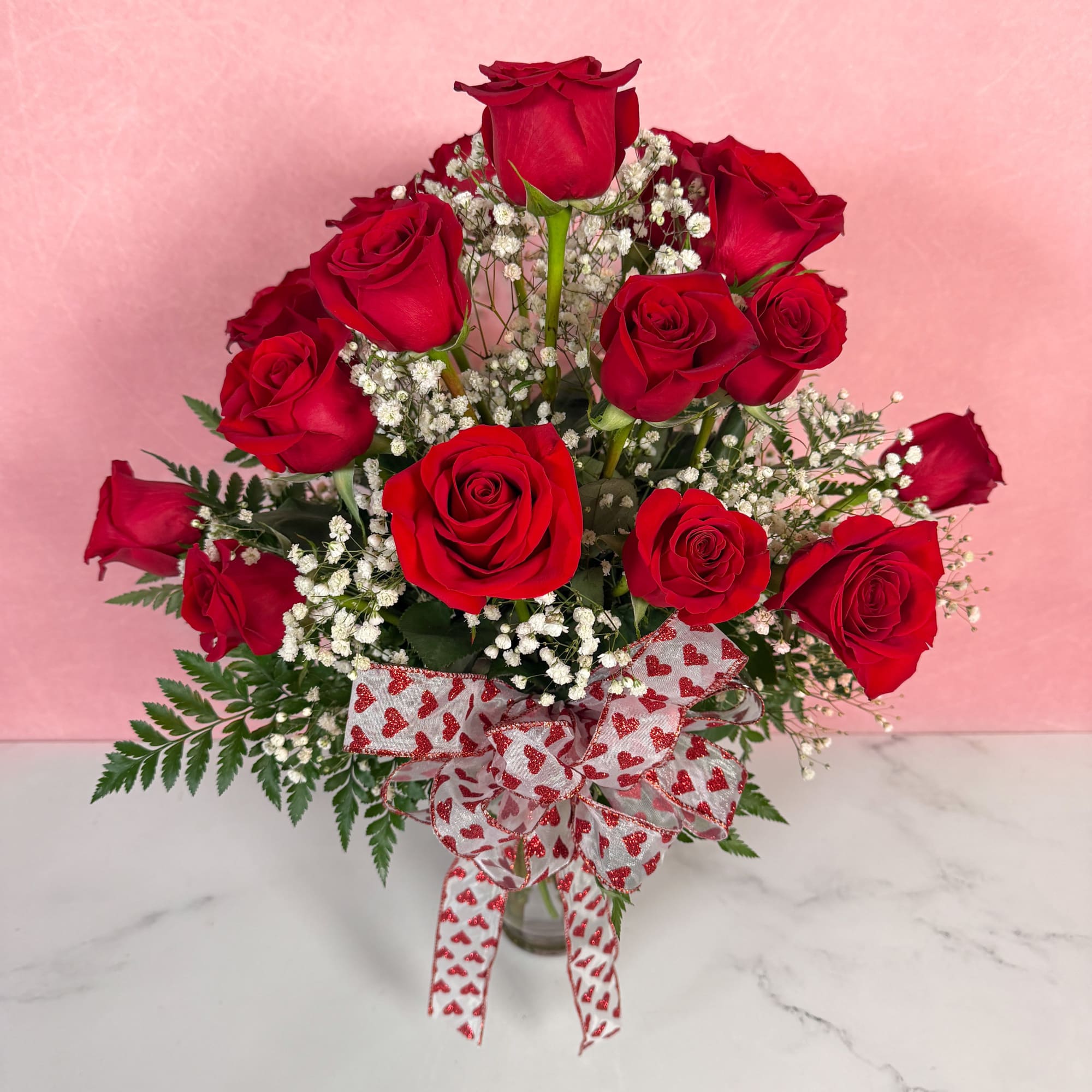 The Classic rendition of One Dozen Red Roses Vased by Savilles Florist
