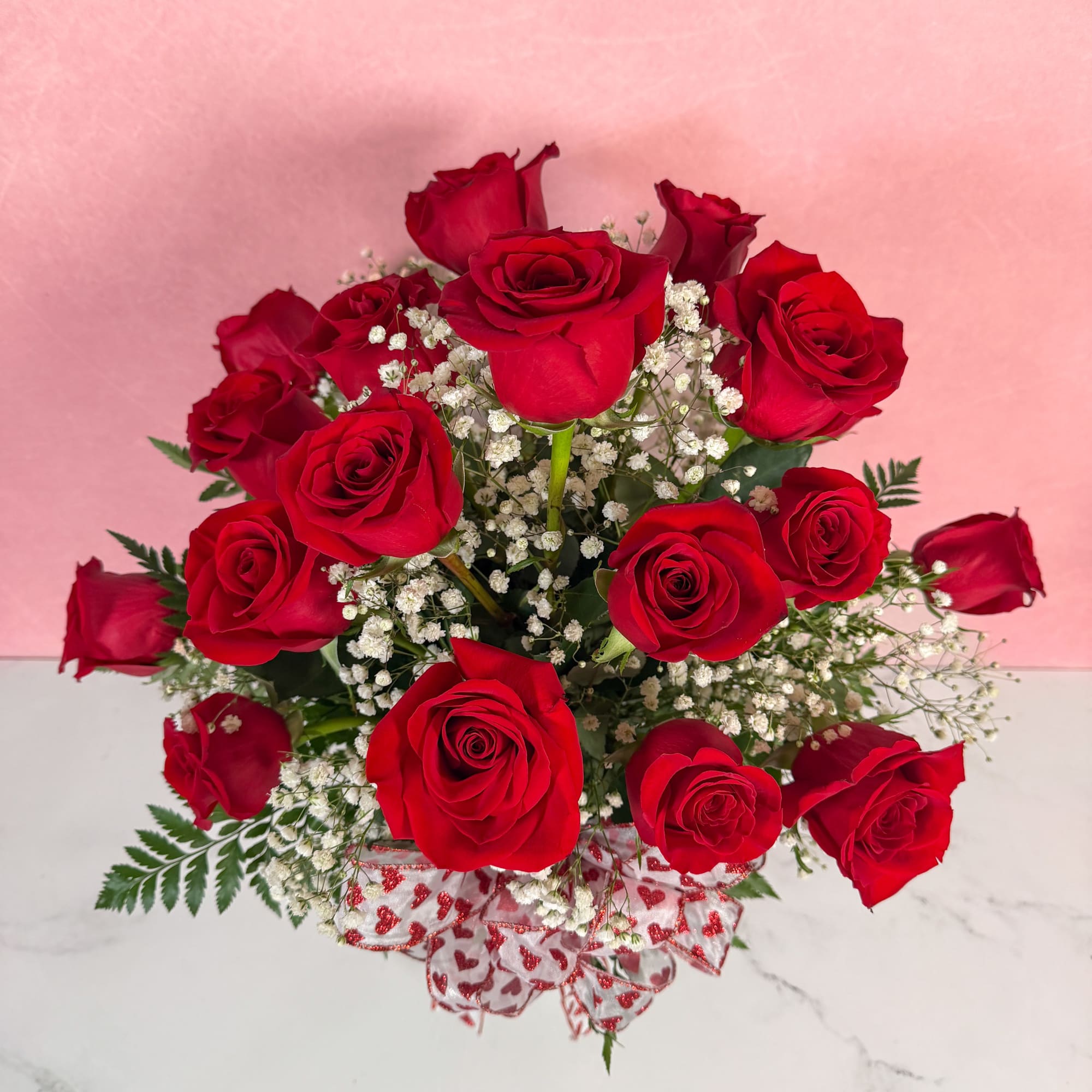 The Classic rendition of One Dozen Red Roses Vased by Savilles Florist
