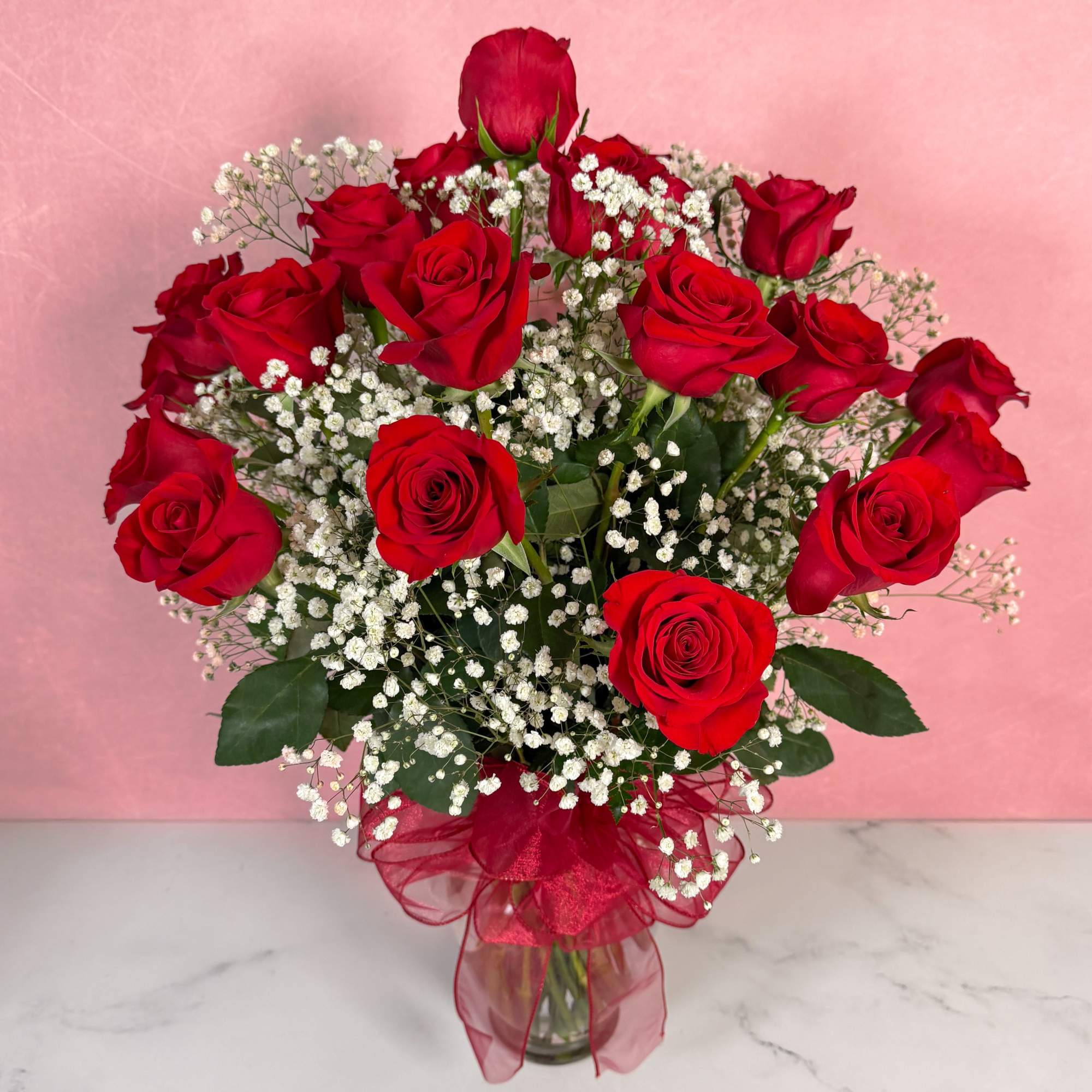 The Classic rendition of One Dozen Red Roses Vased by Savilles Florist