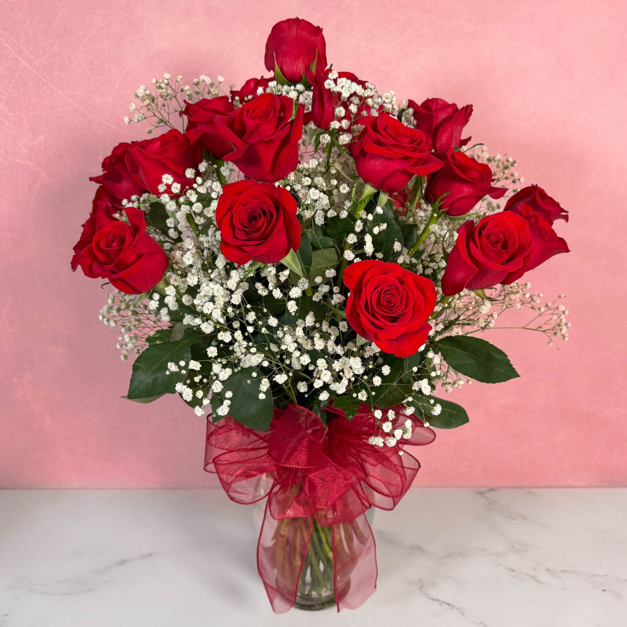 The Classic rendition of One Dozen Red Roses Vased by Savilles Florist
