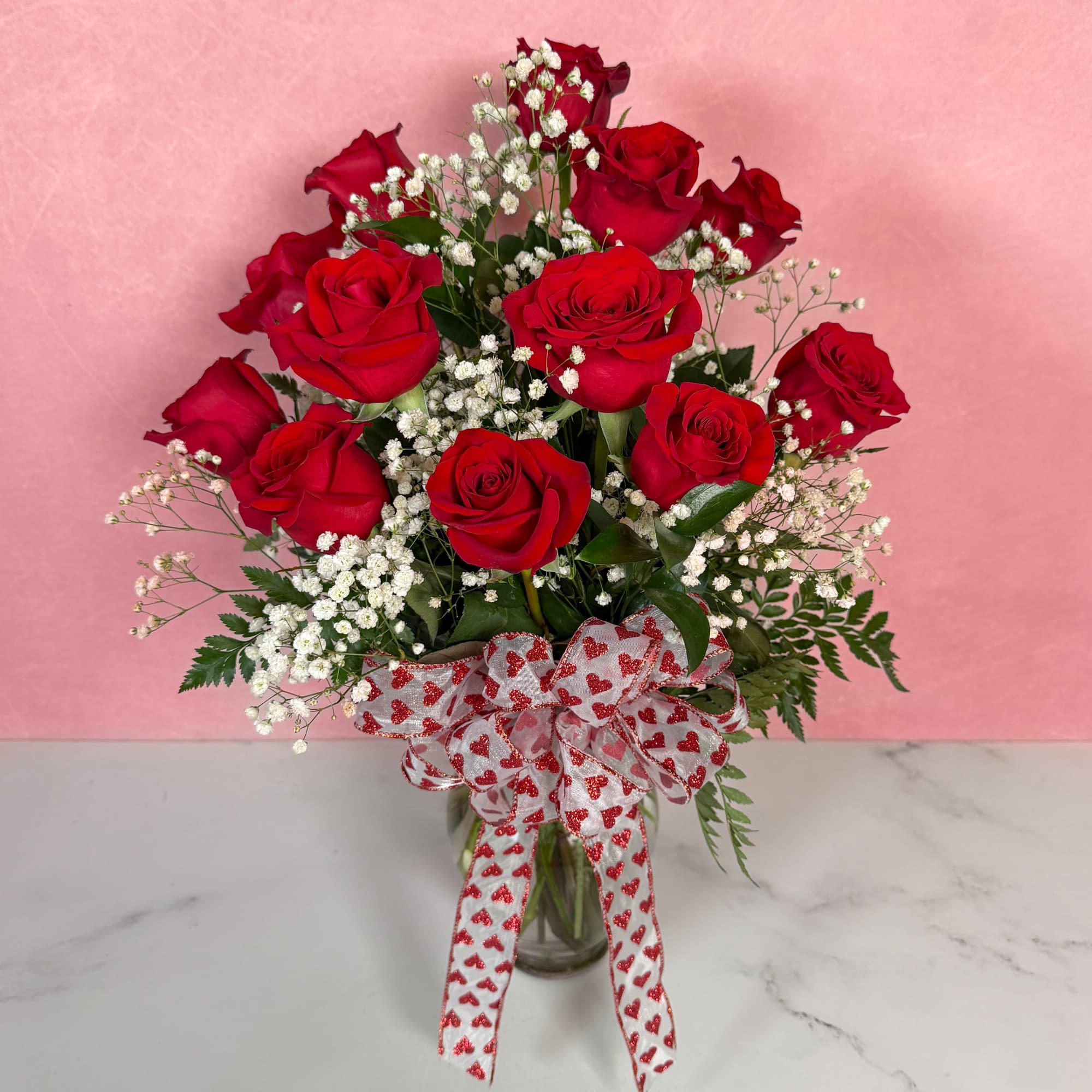 The Classic rendition of One Dozen Red Roses Vased by Savilles Florist