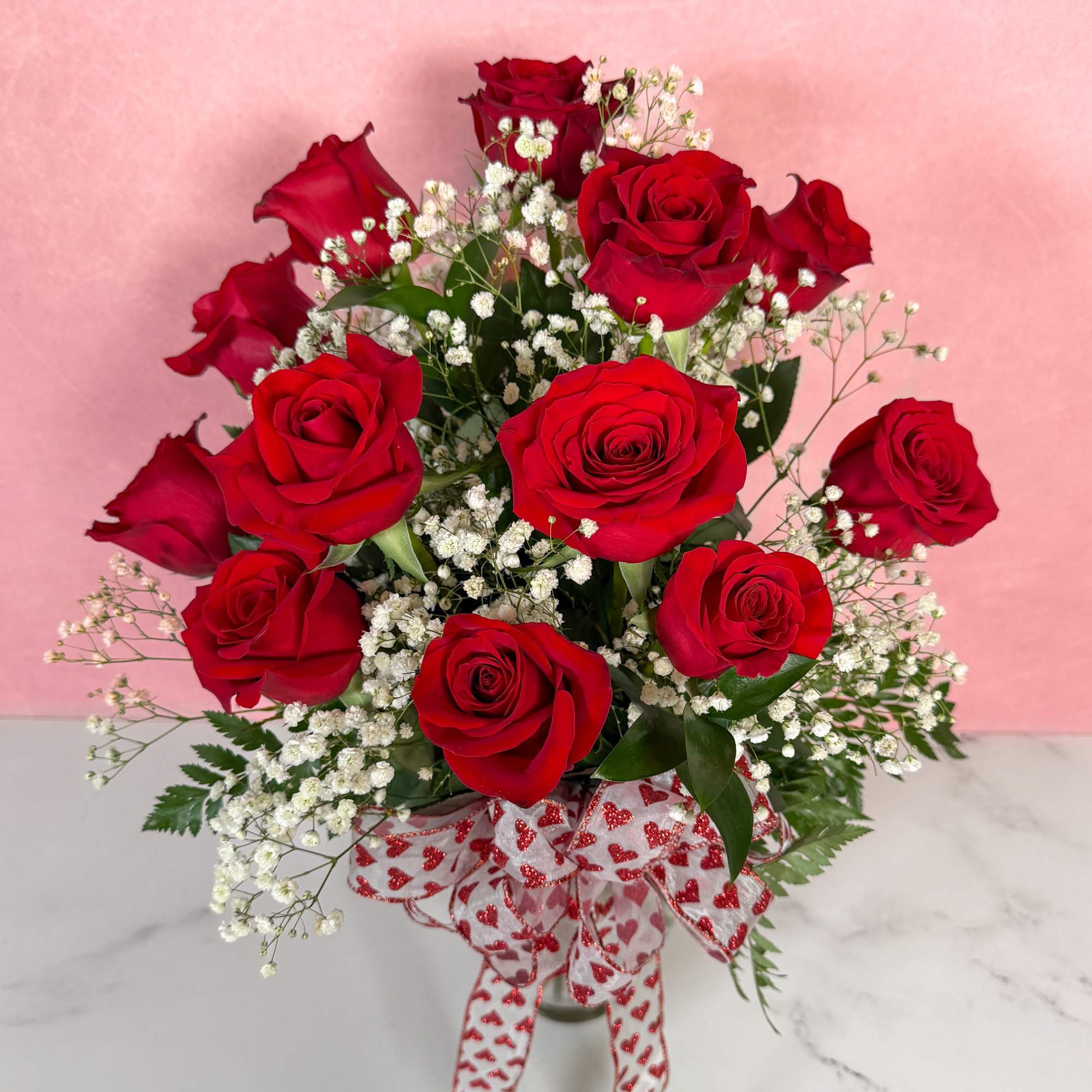 The Classic rendition of One Dozen Red Roses Vased by Savilles Florist