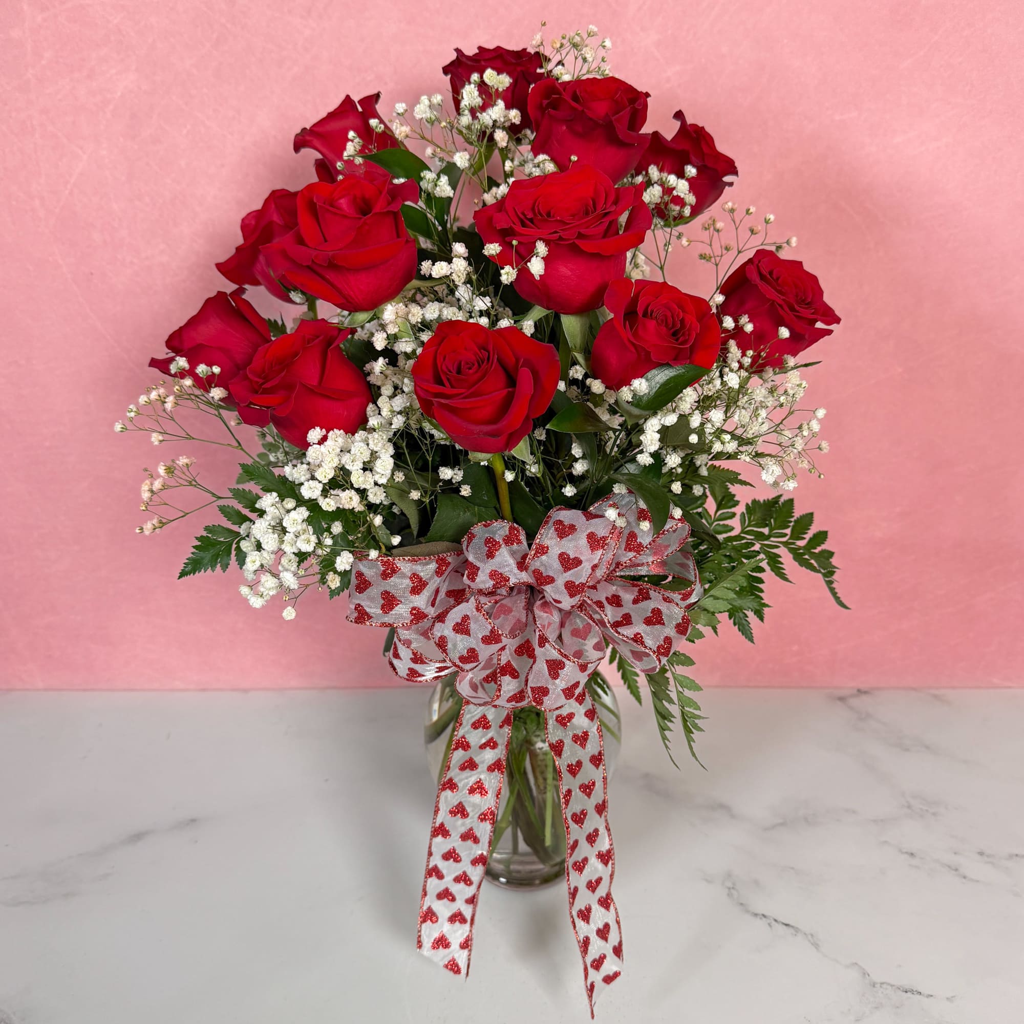 The Classic rendition of One Dozen Red Roses Vased by Savilles Florist