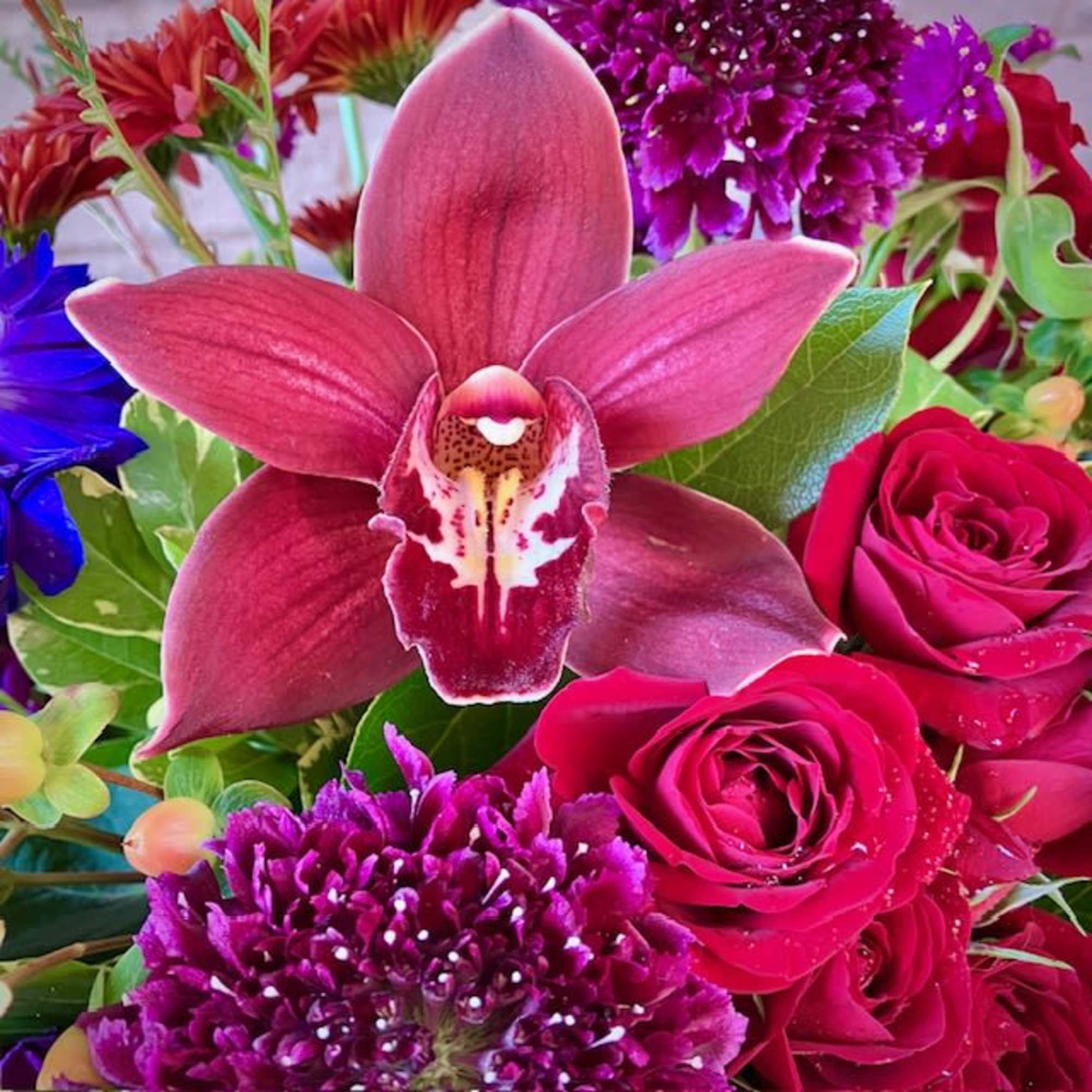 Send a mystical and whimsical floral design with the Spellbound arrangement, perfect