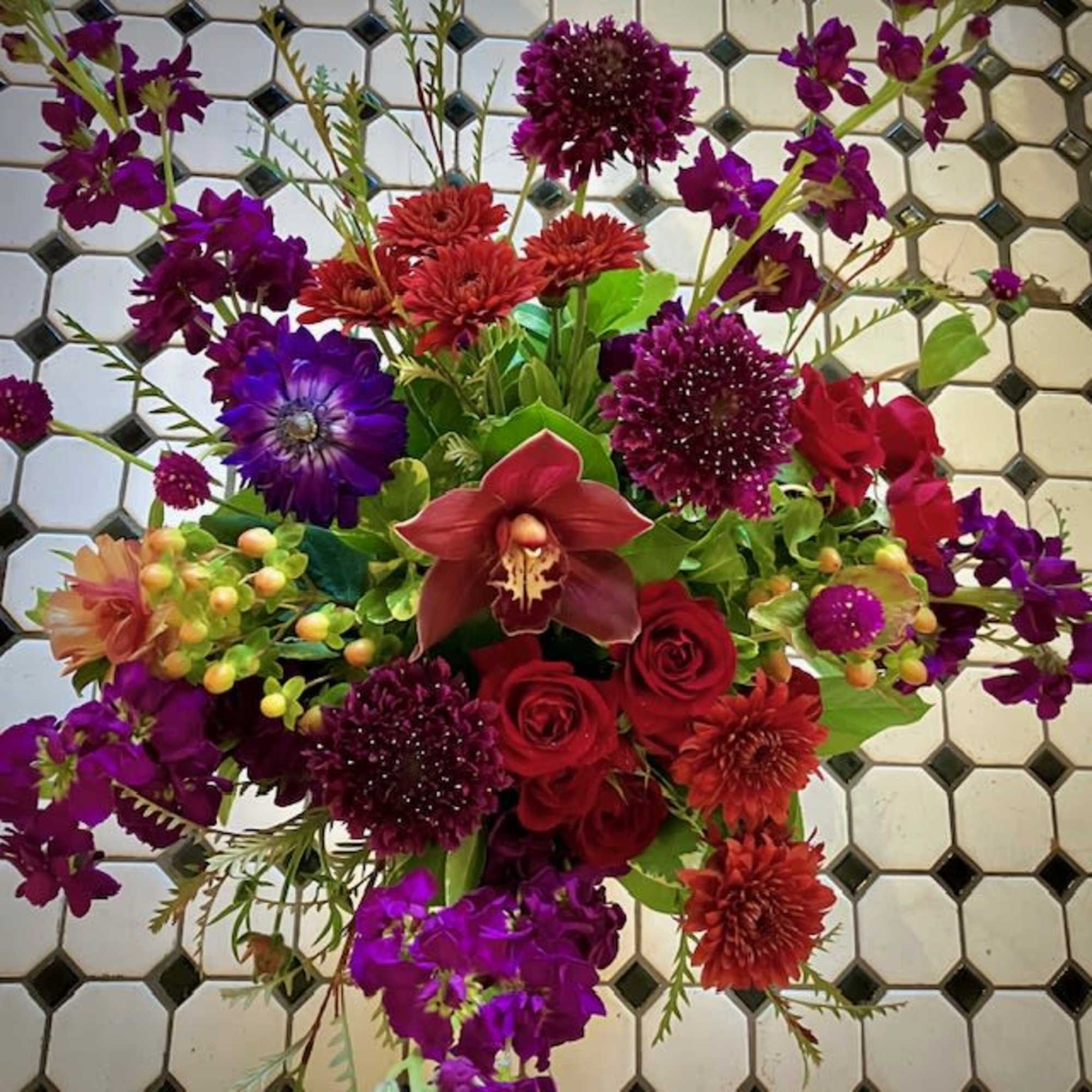 Send a mystical and whimsical floral design with the Spellbound arrangement, perfect