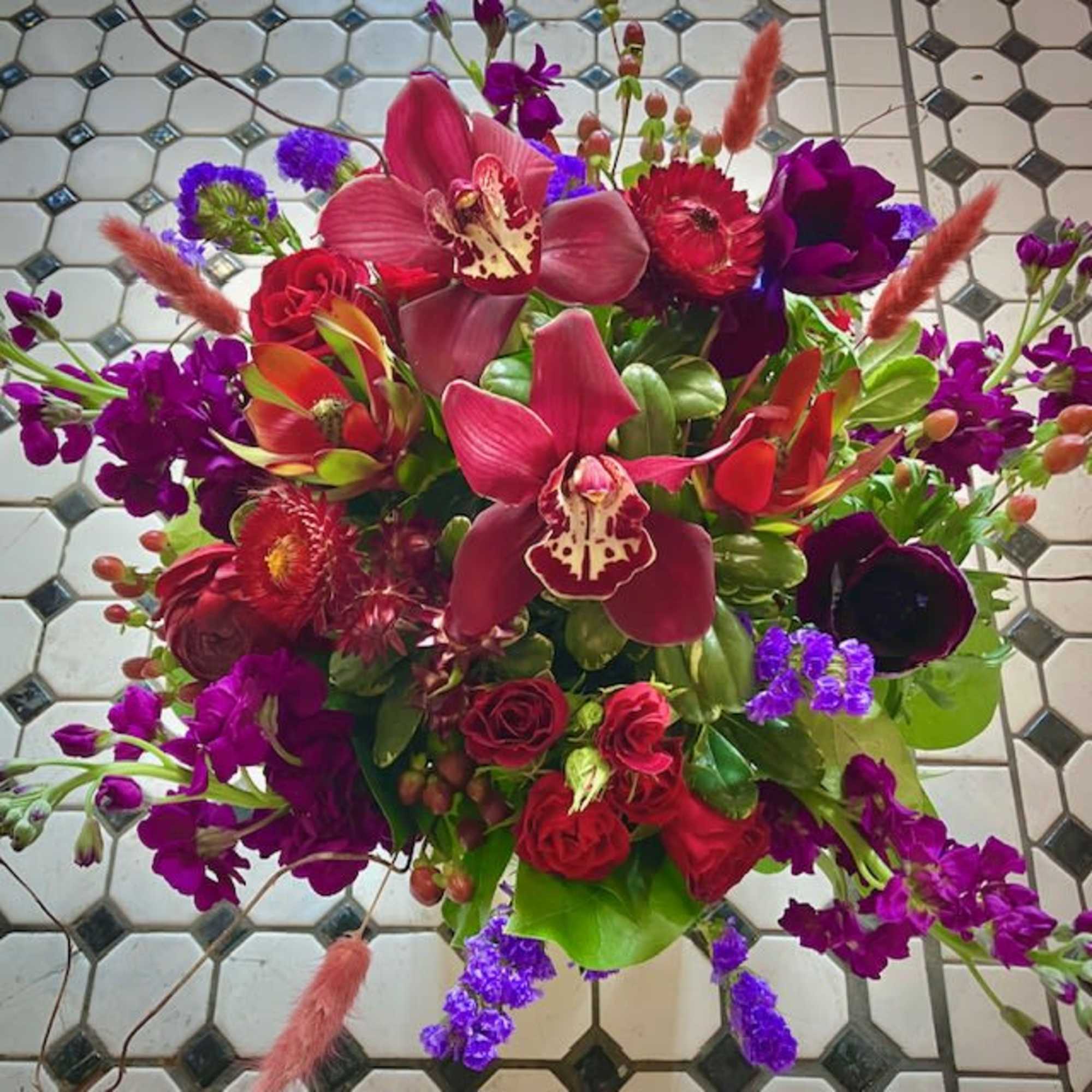 Send a mystical and whimsical floral design with the Spellbound arrangement, perfect