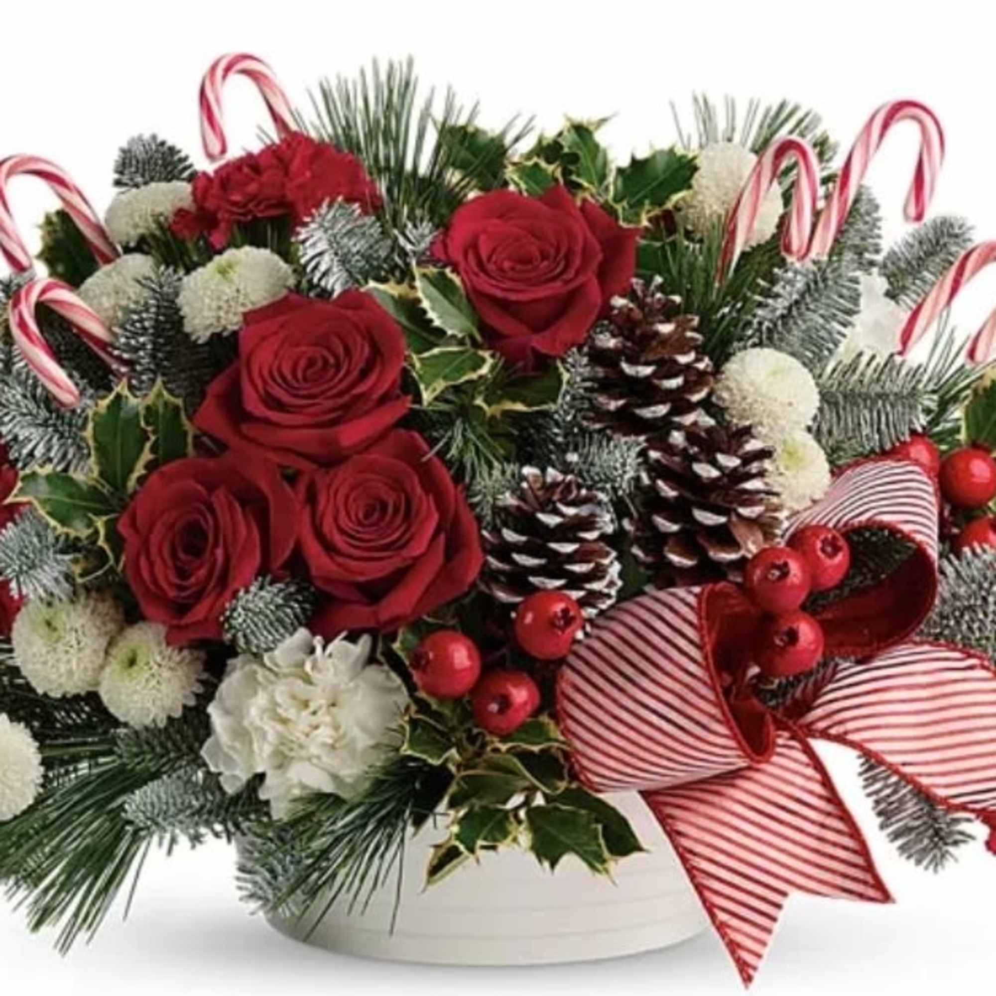 Drawing attention with festive candy canes, this classic Christmas arrangement encapsulates the