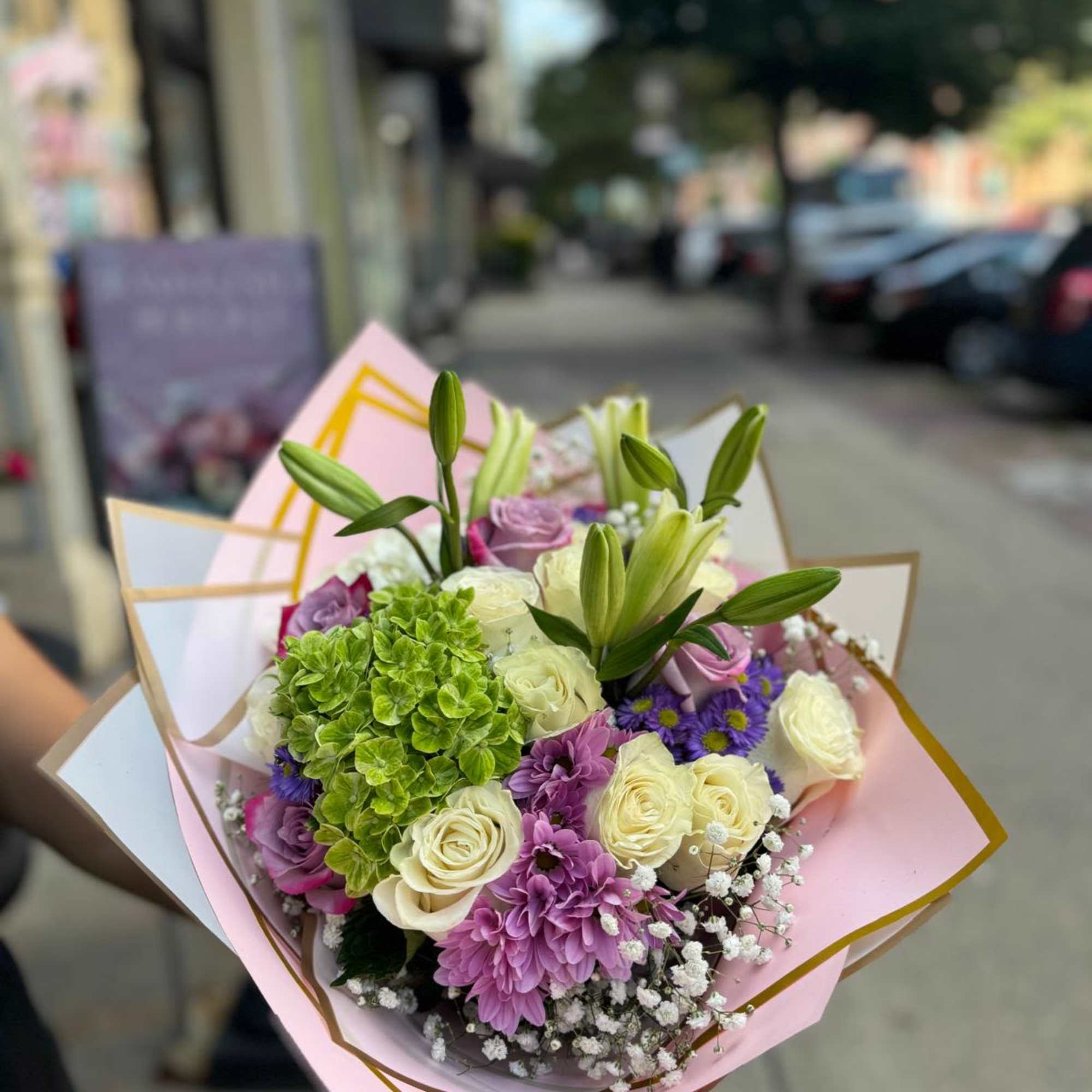 "Lavender Dreams" is an elegant floral arrangement that combines the purity of