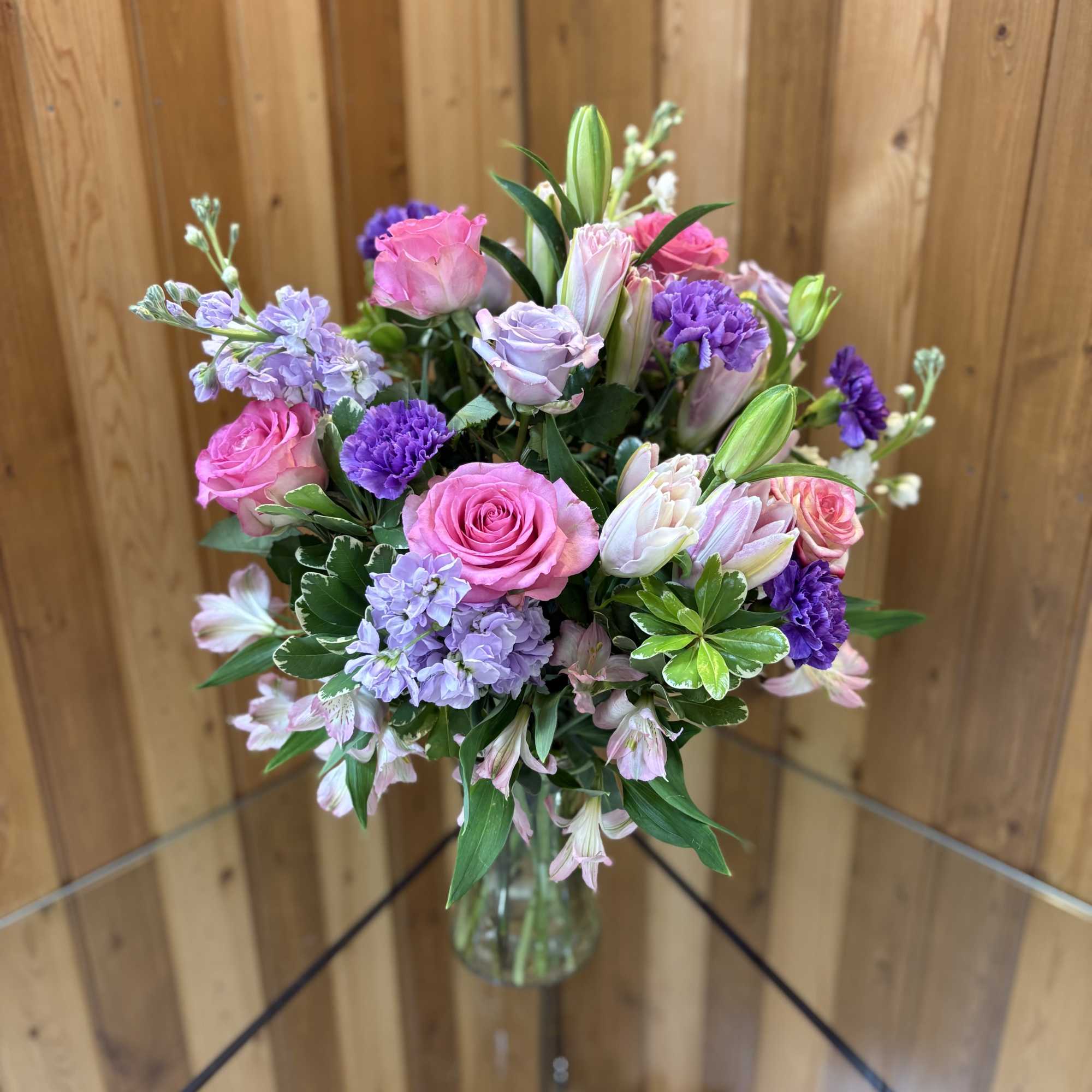 Vase arrangement of a variety of flowers.