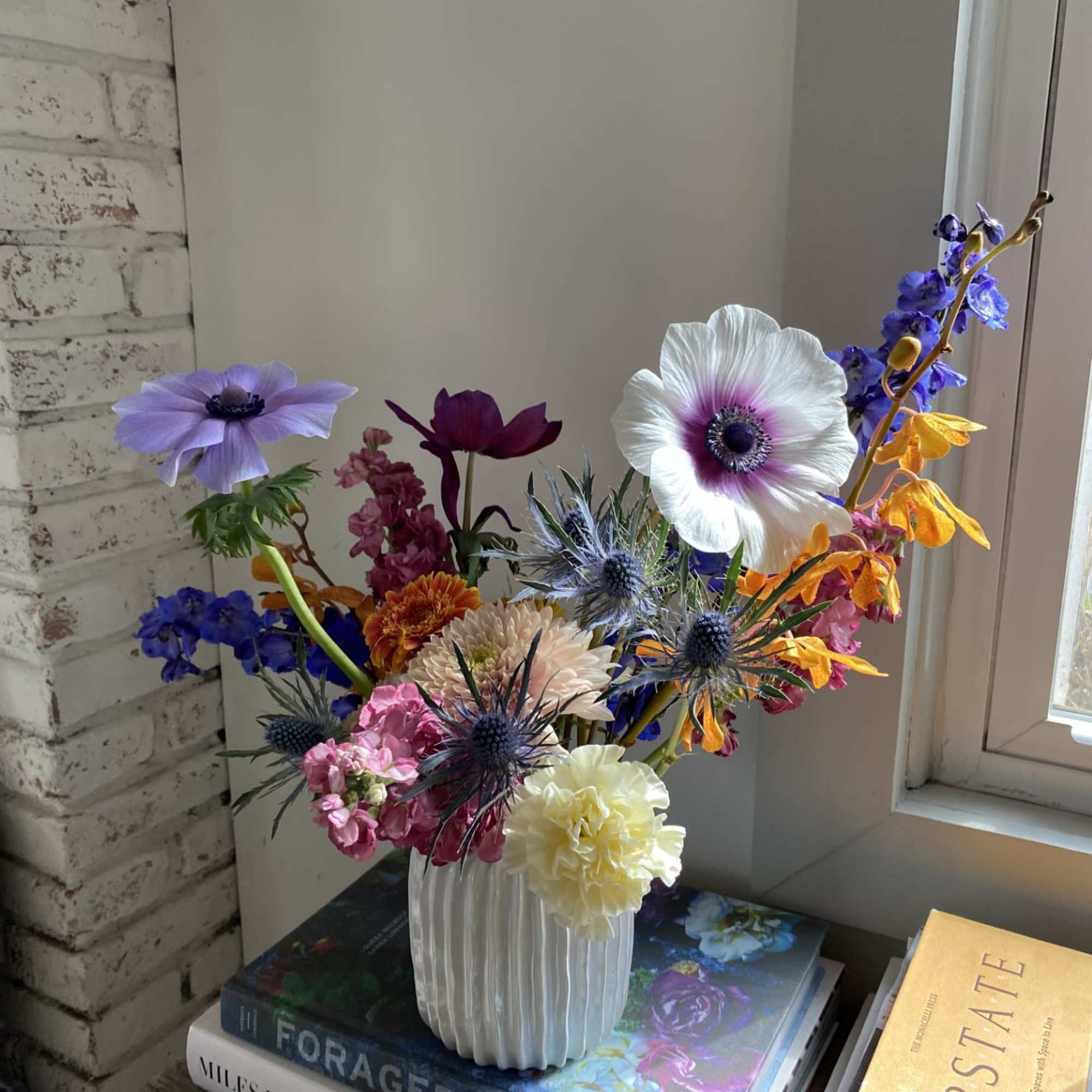 A whimsical assortment of seasonal blooms, unique fillers, and dried goods. A