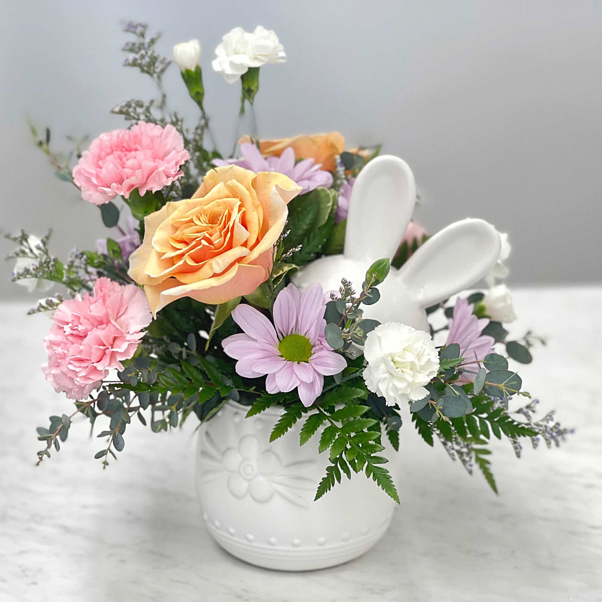 Spring flowers in a ceramic egg with bunny ears!! Perfect for an