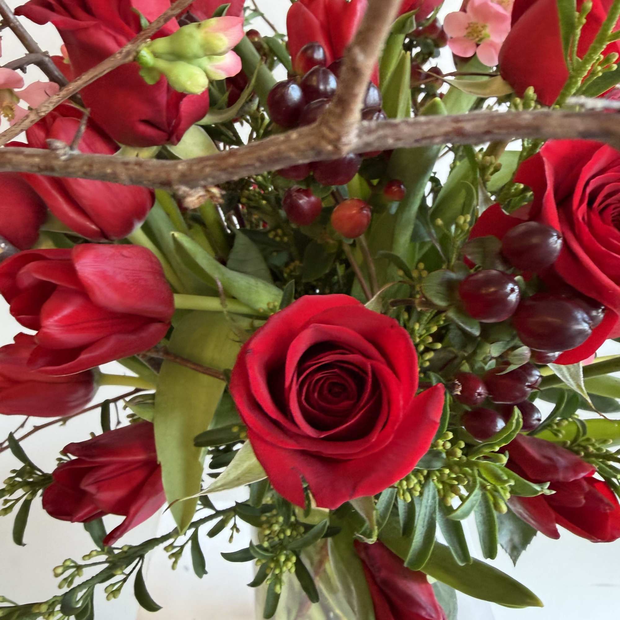 beautiful red tulips 
red roses 
Pink quince flowering branched 
Hypericum burgundy 