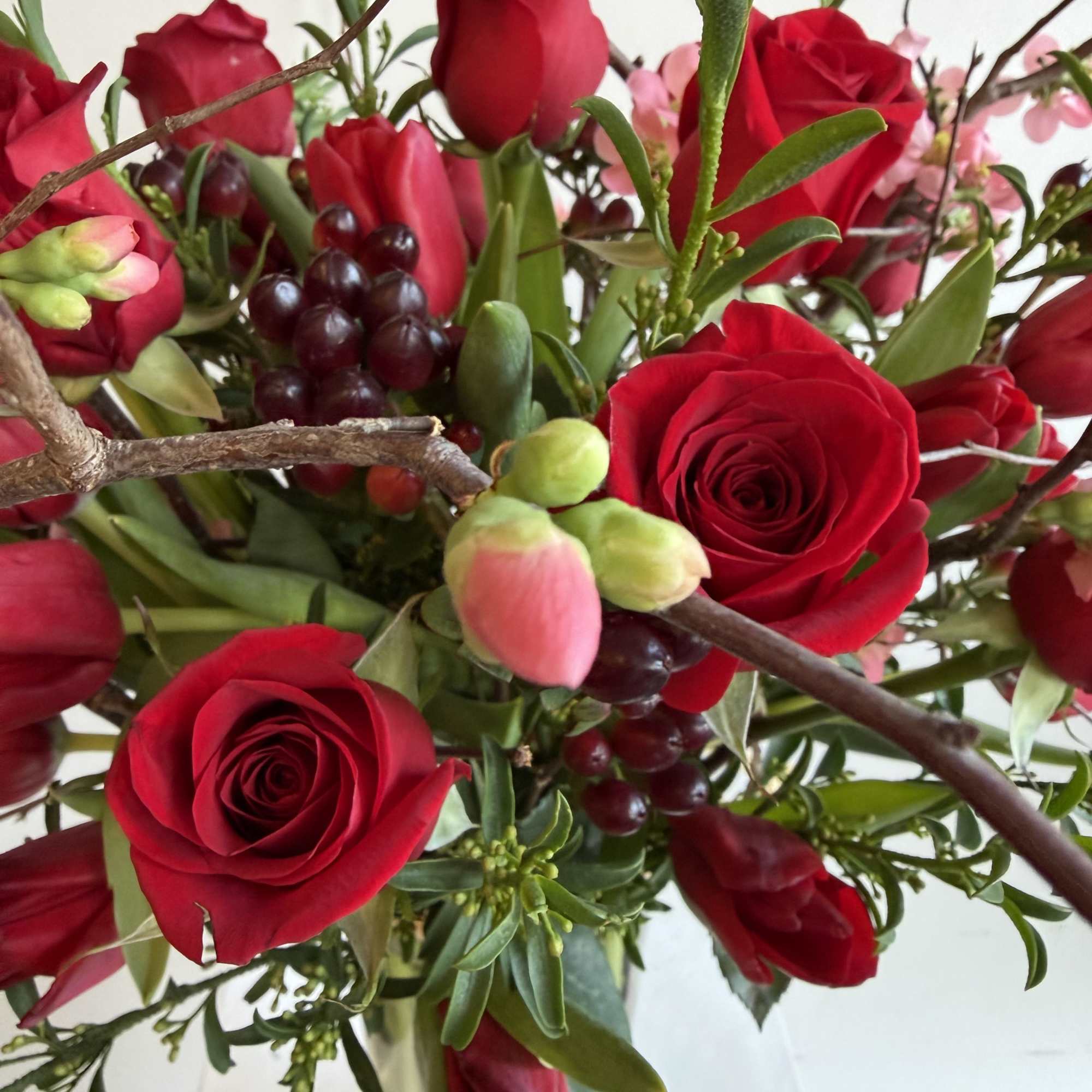 beautiful red tulips 
red roses 
Pink quince flowering branched 
Hypericum burgundy 