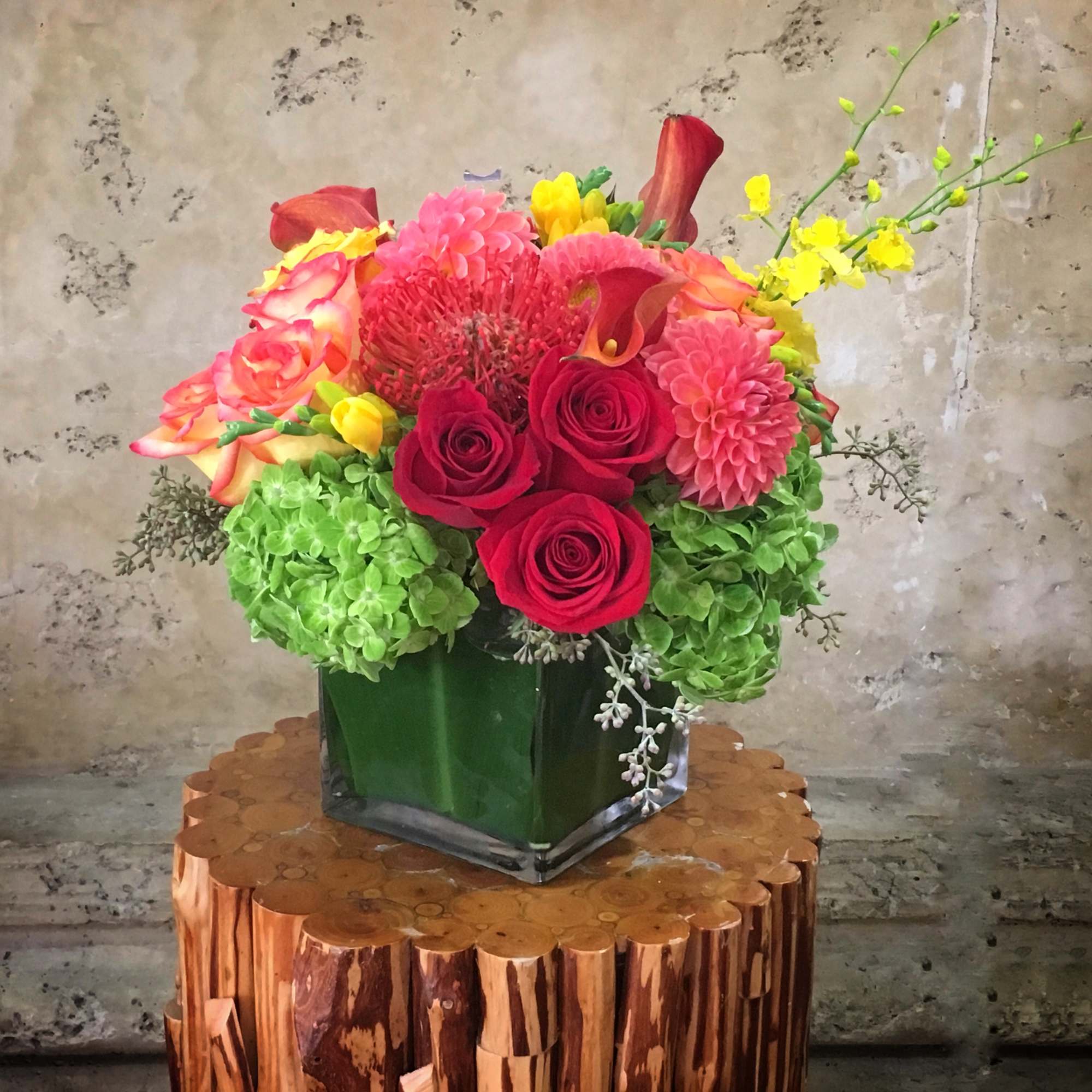 This is a rich, autumn-inspired floral arrangement with a warm, dramatic palette