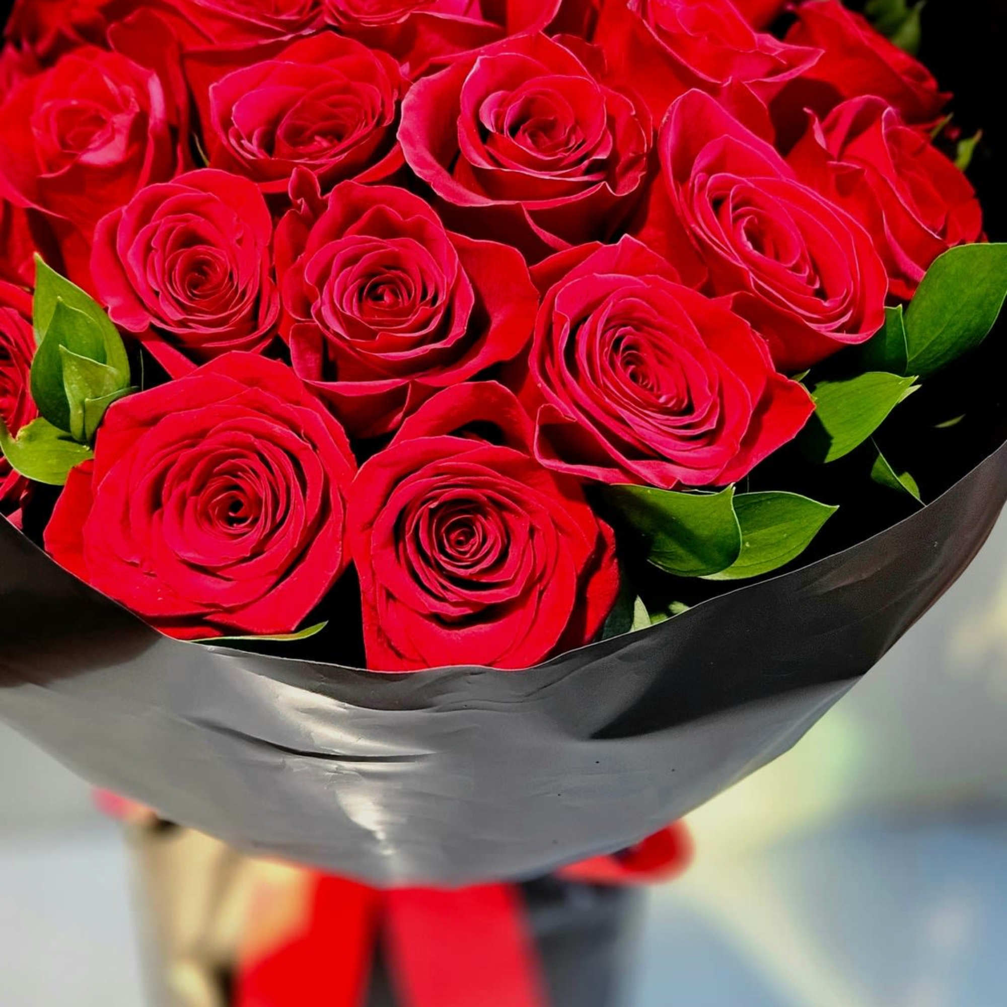 Two dozen premium red Roses wrapped in paper. (Available in White, Pink