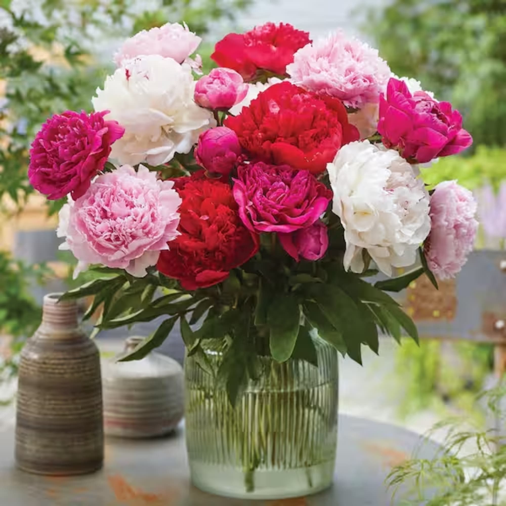 We gather the prettiest peonies and wrap them with foliage and hand