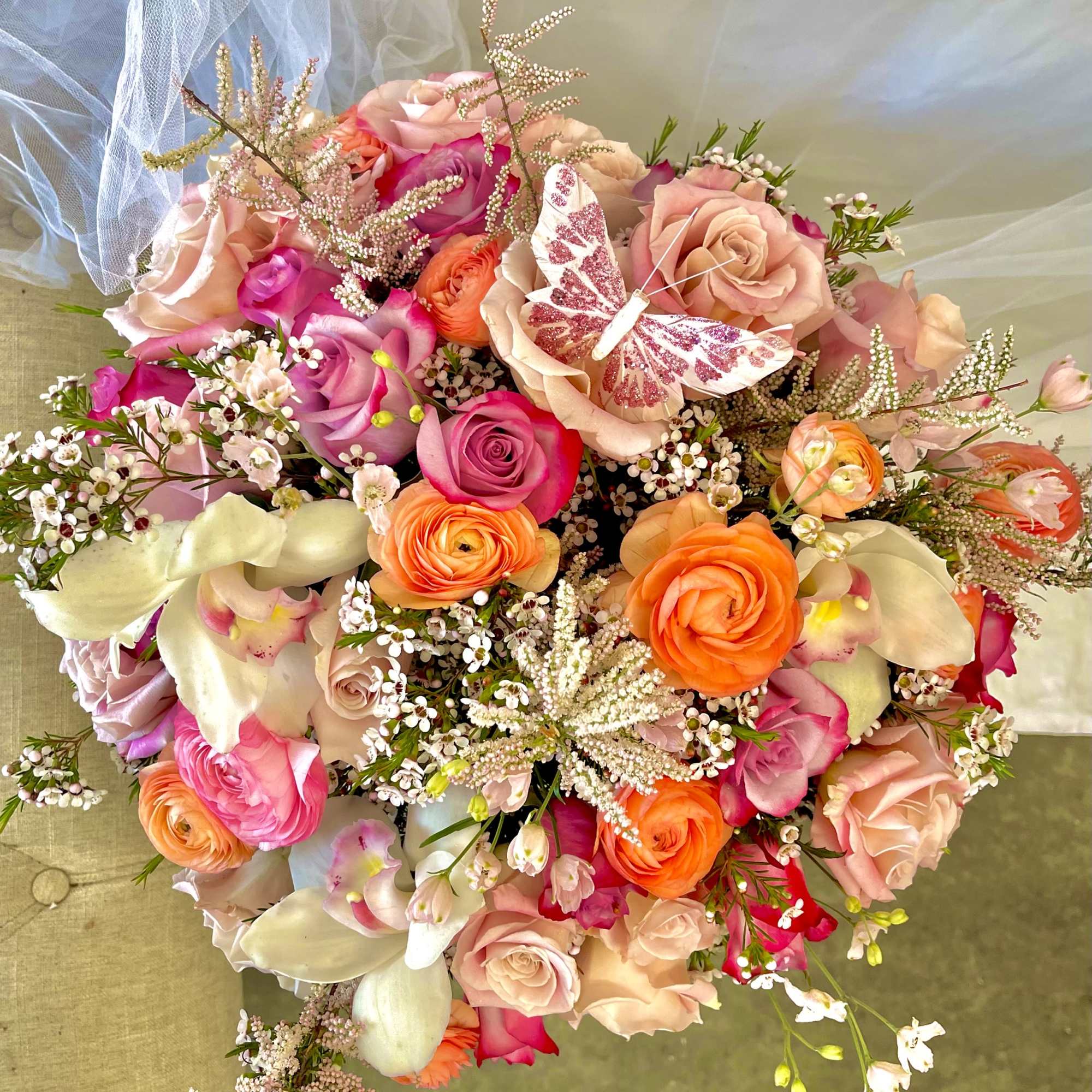 Theme Colors: Shades of pinks, peaches and purple, White.

Featured Blooms: Roses, Spray