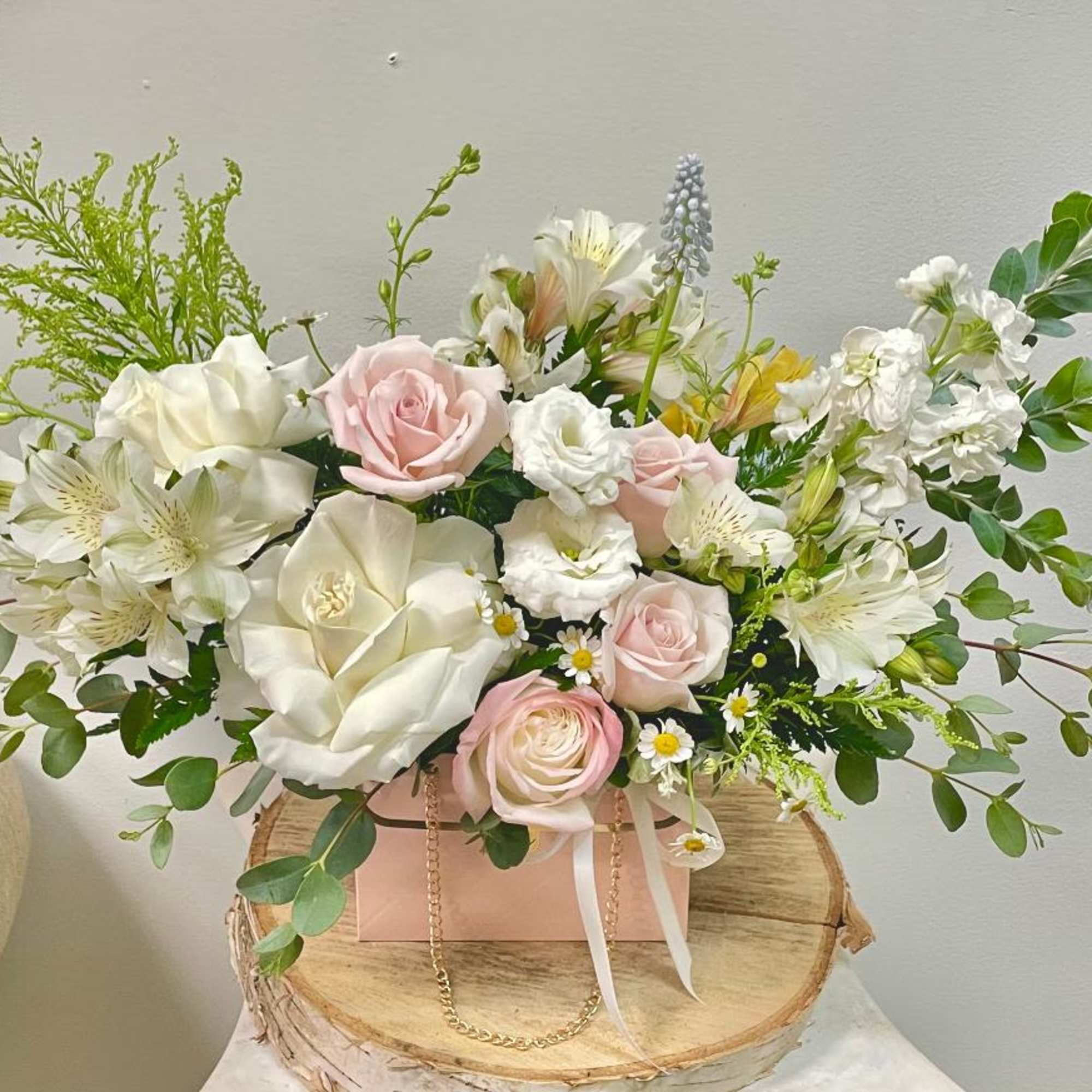 

Product Information
Theme Colors: Shades of white, peachy, pink

Featured Blooms: Roses, Stock, muscari