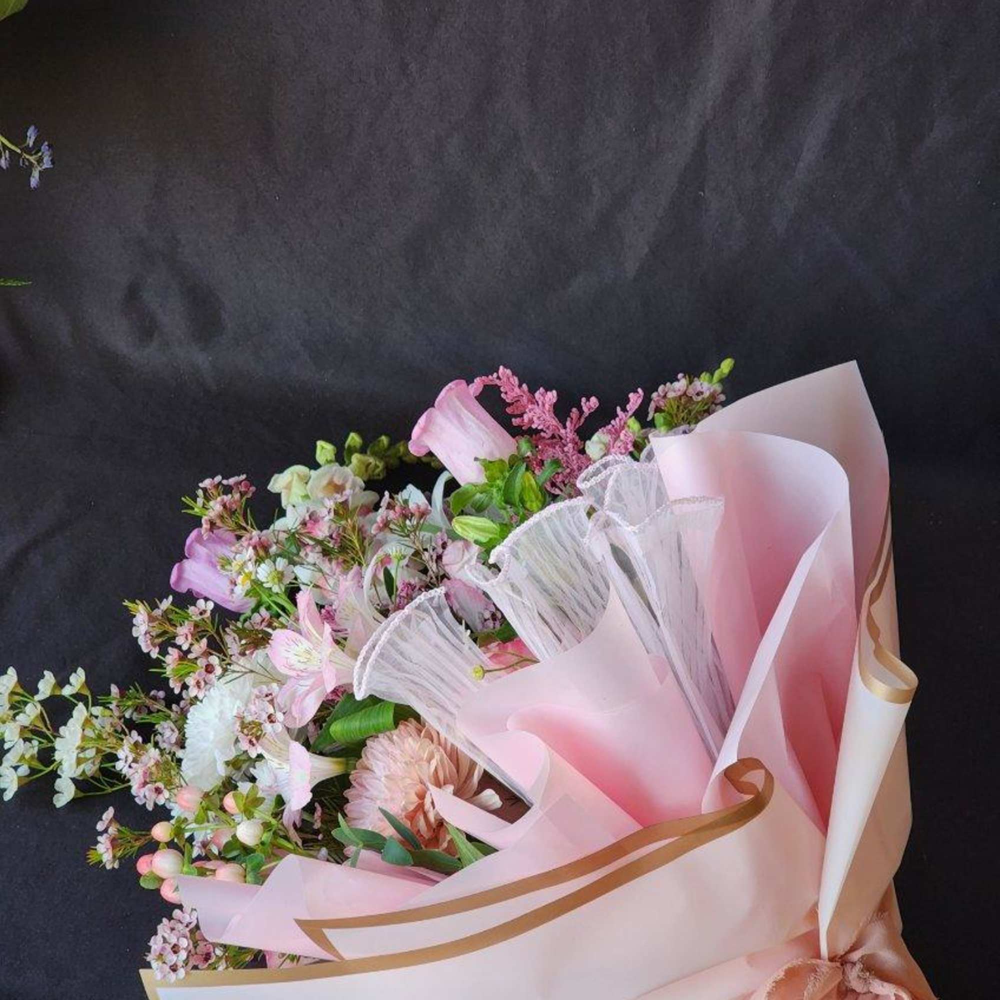 Feminine, Romantic and Pure bliss! The bouquet is wrapped in pink ruffled