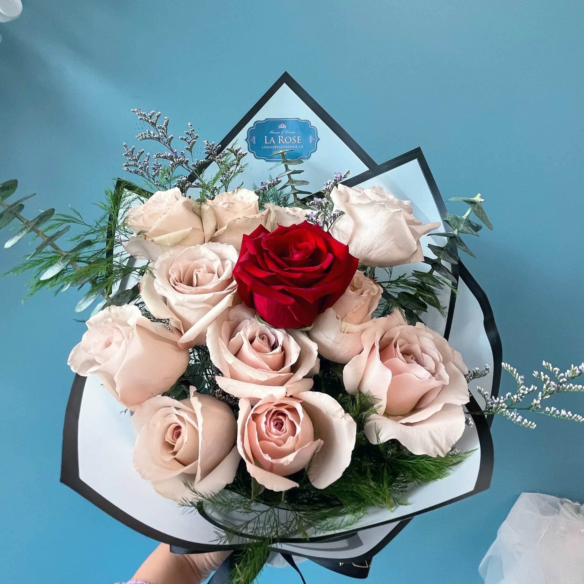 Indulge in the elegance of premium roses, beautifully arranged with complementary floral