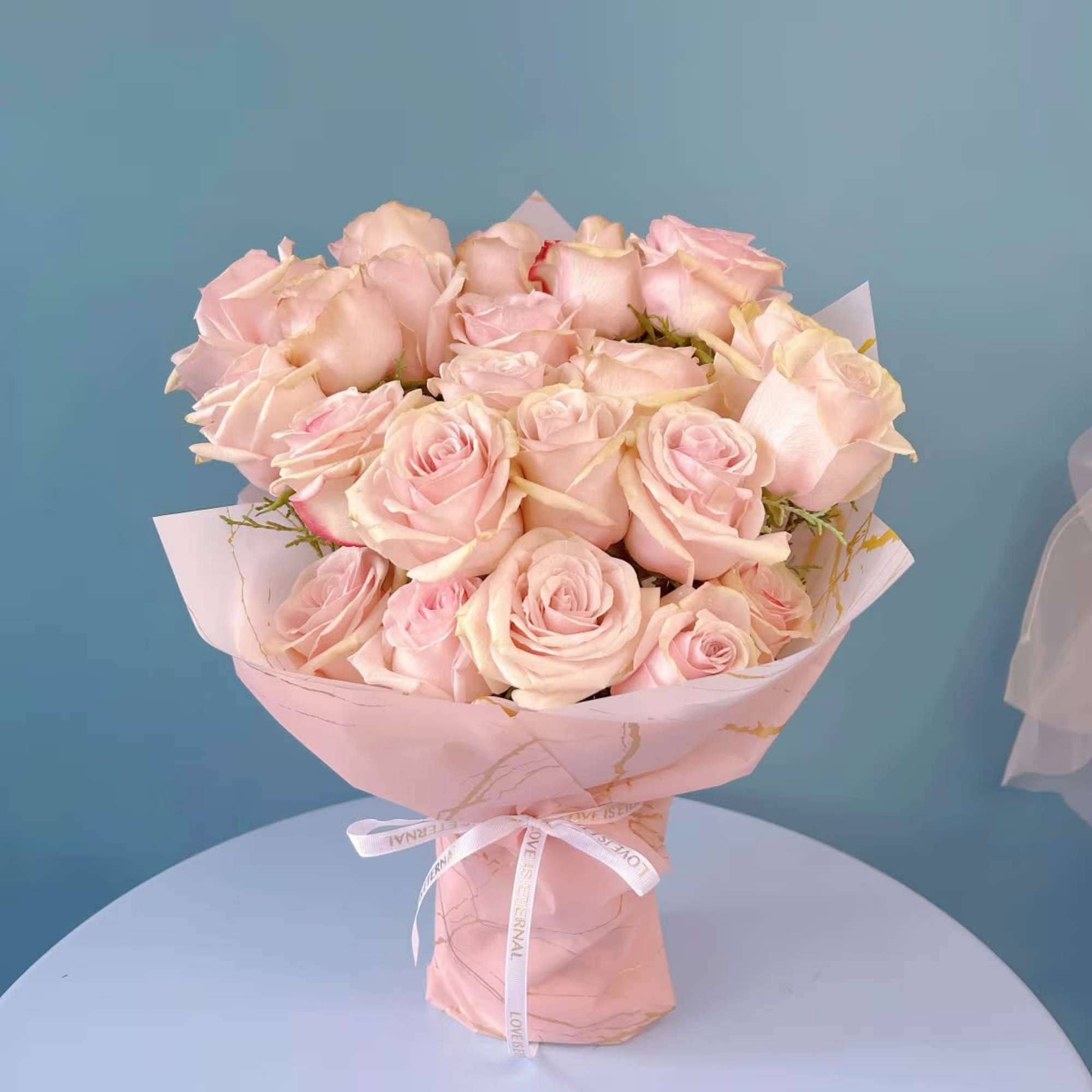 Indulge in the elegance of premium roses, beautifully arranged with complementary floral