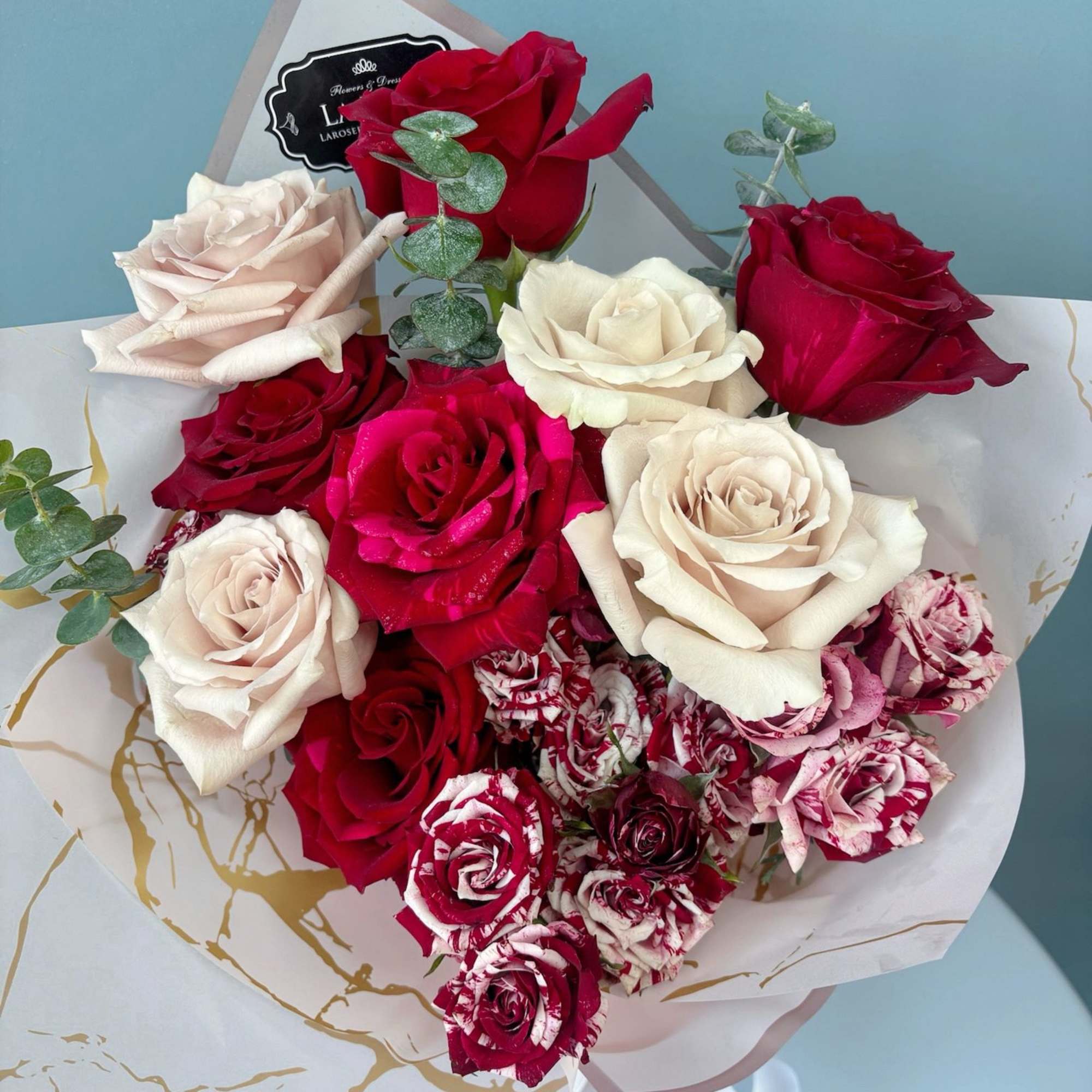 Indulge in the elegance of premium roses, beautifully arranged with complementary floral