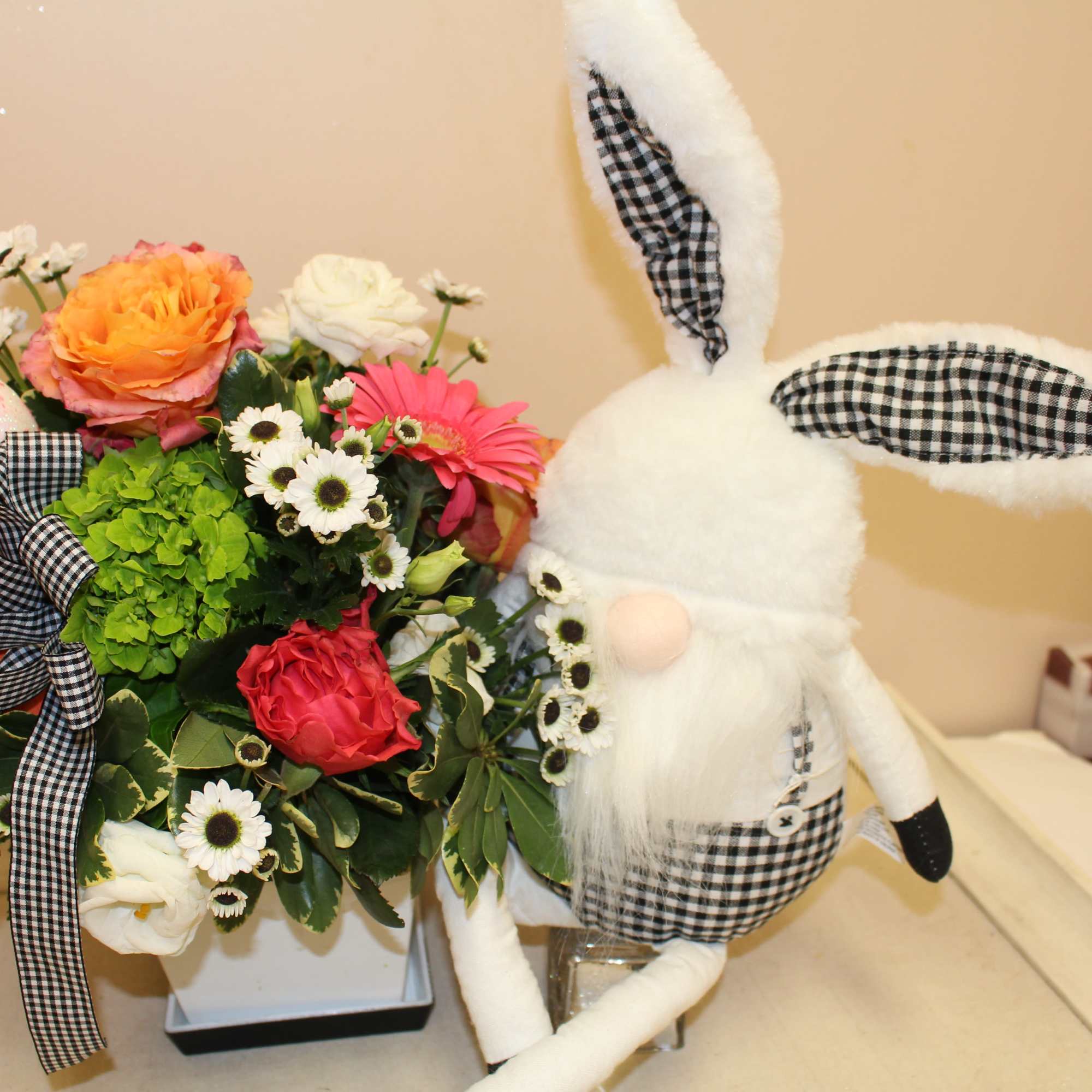 This fresh arrangement includes spring blooms, including the sweet black and white