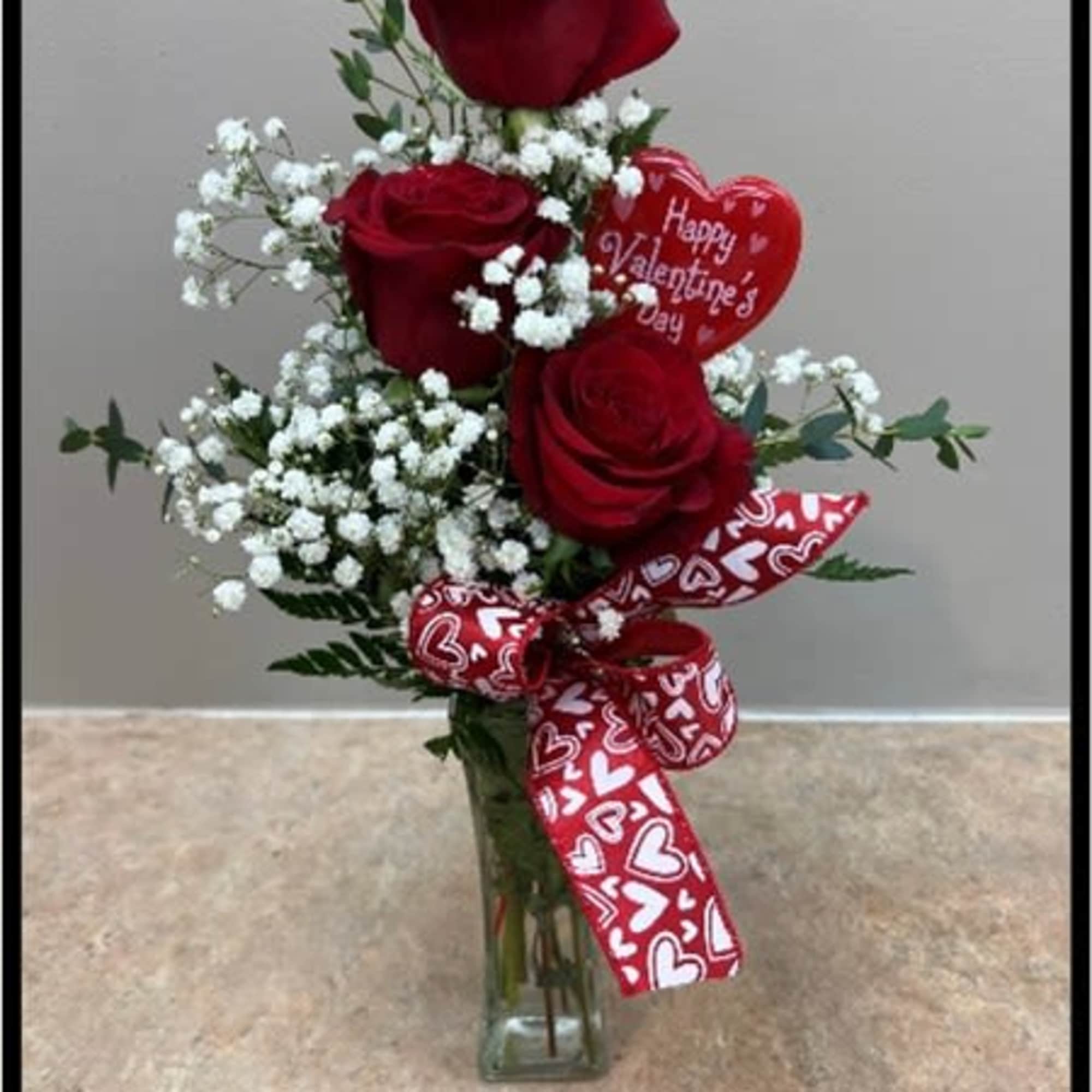 3-Rose Budvase with greenery and filler and a bow.