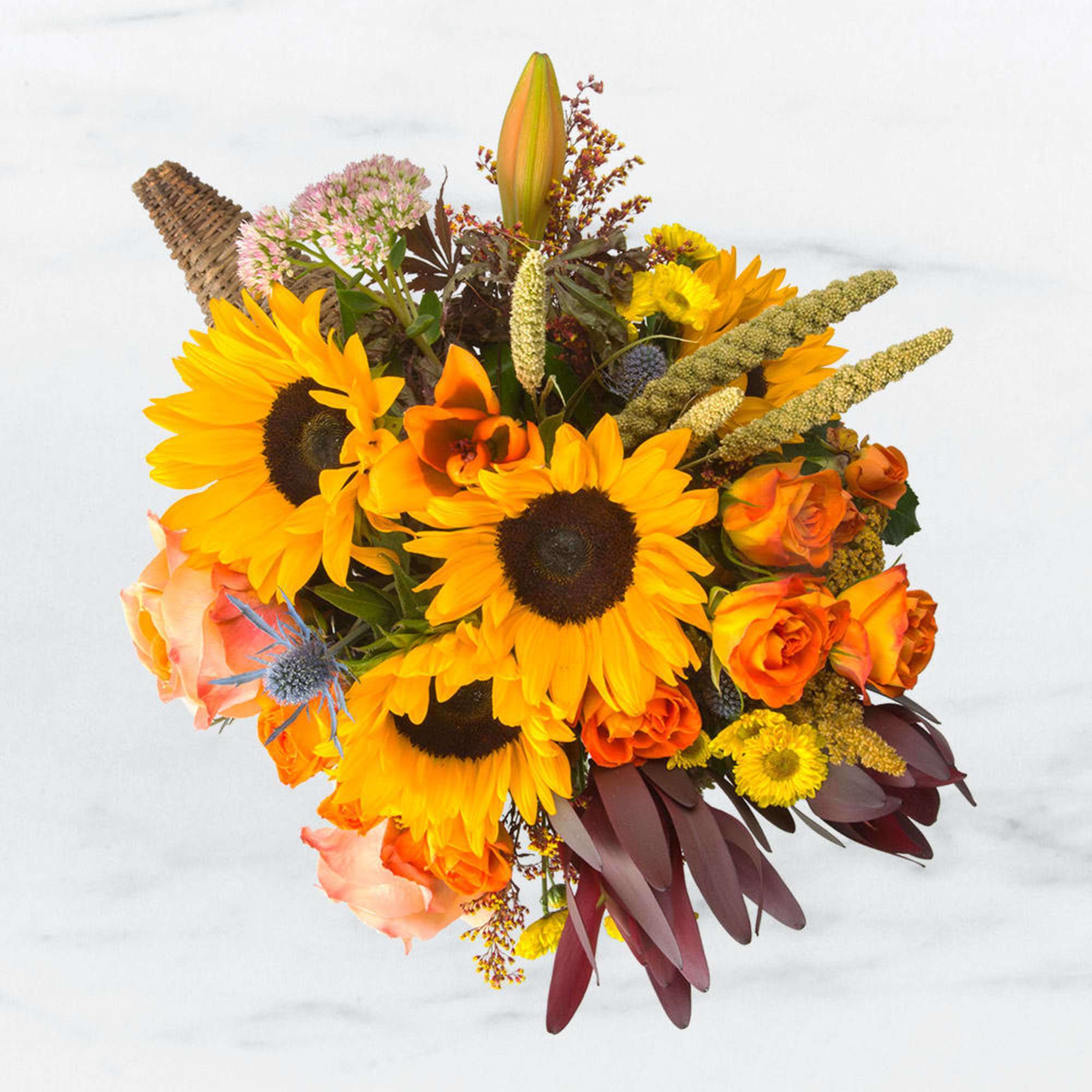 Celebrate the richness of the harvest season with our stunning cornucopia centerpiece.