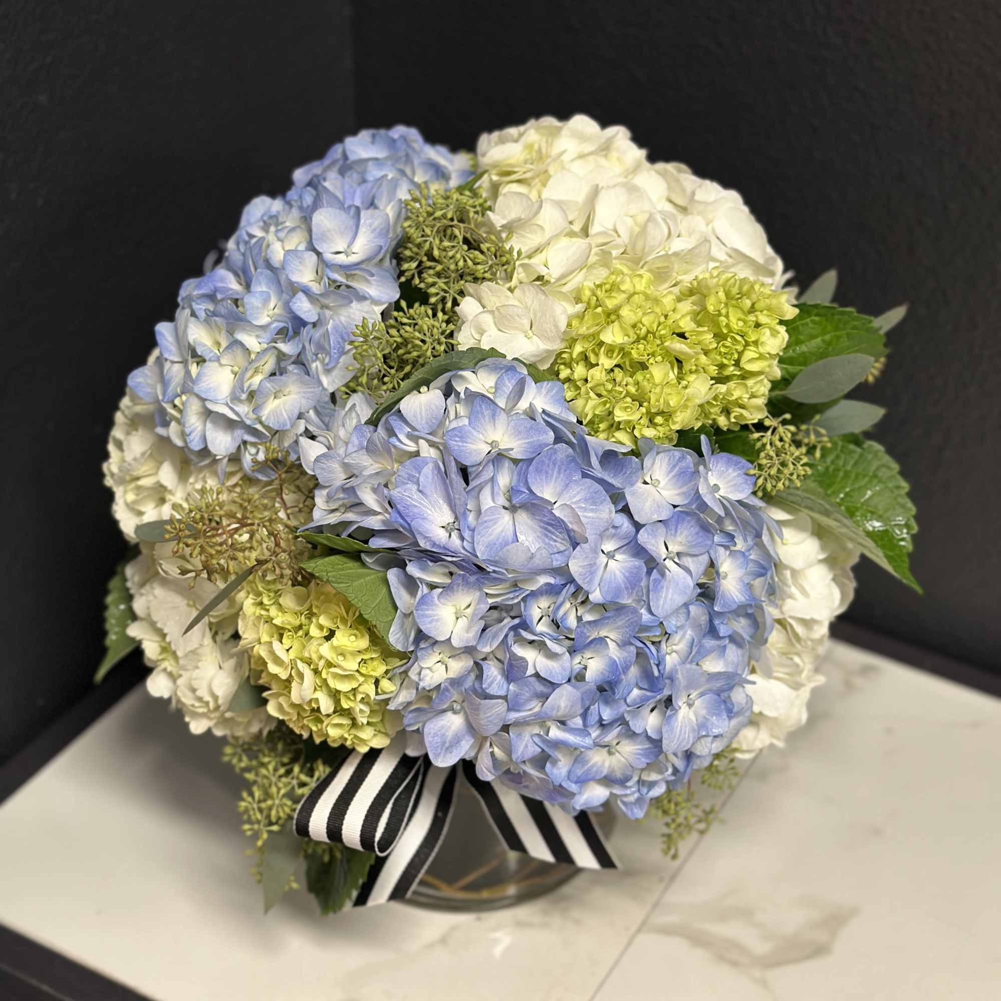 An elegant option for any occasion. Mixed hydrangea's en masse delivered in