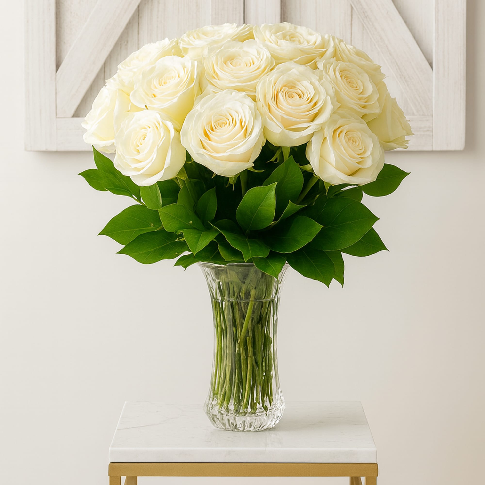 A serene display of premium white roses arranged in a clear glass