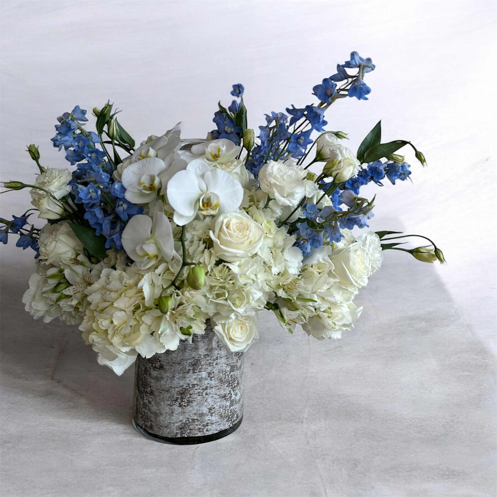 lisianthus with hydrangea, delphinium, white orchid, playa Blanca roses
