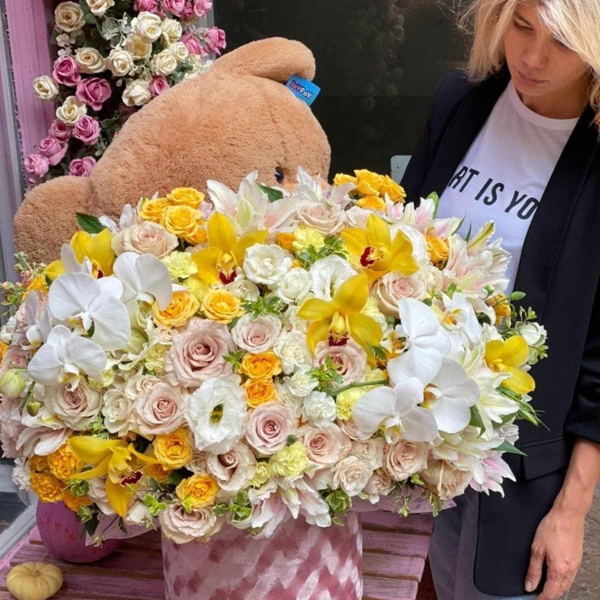 Arleta is a beautiful floral arrangement with white orchids, lilies, nude roses