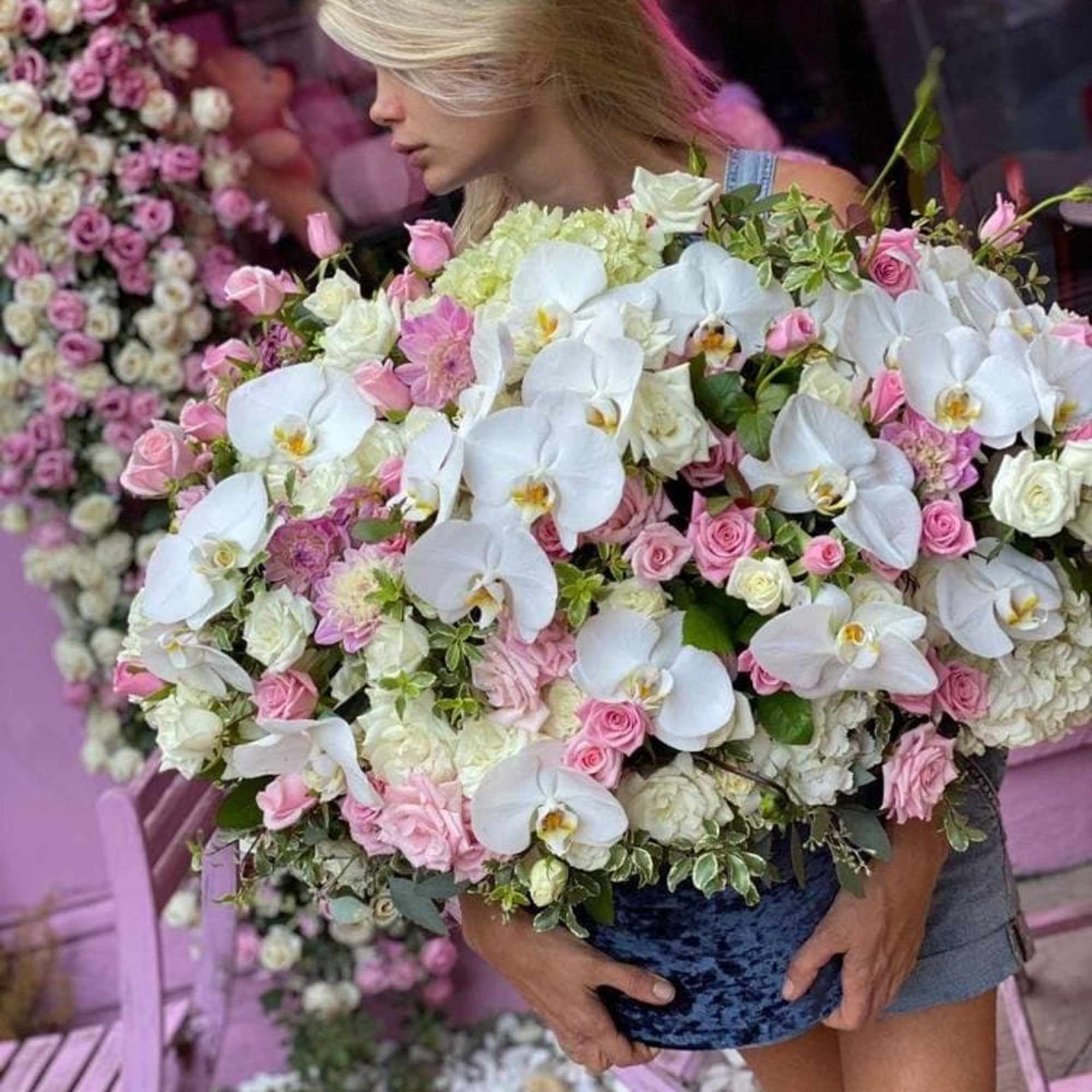 This arrangement consists of white orchids, hydrangea, pink and white roses in
