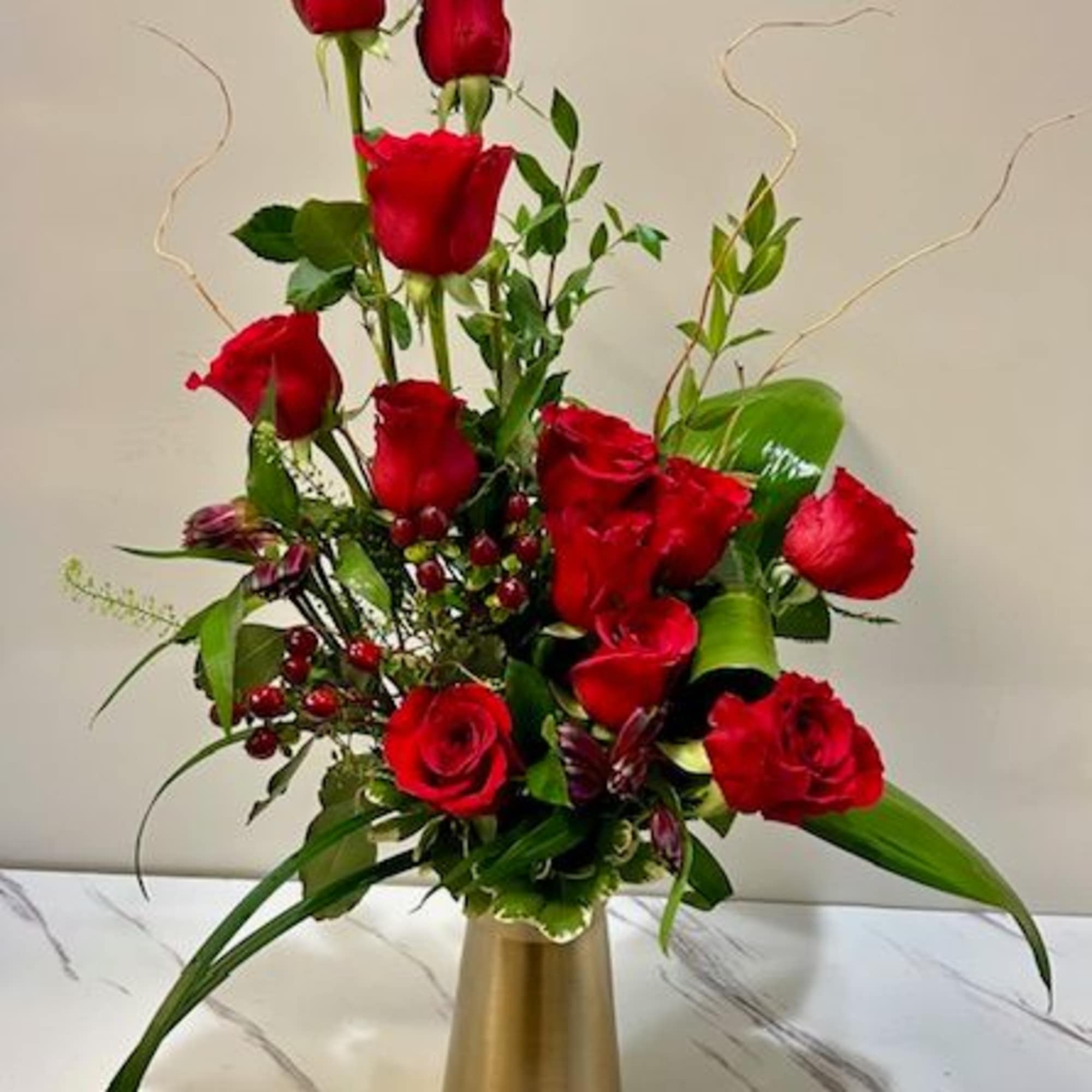 A luxurious twist on the classic red dozen, this upscale arrangement redefines