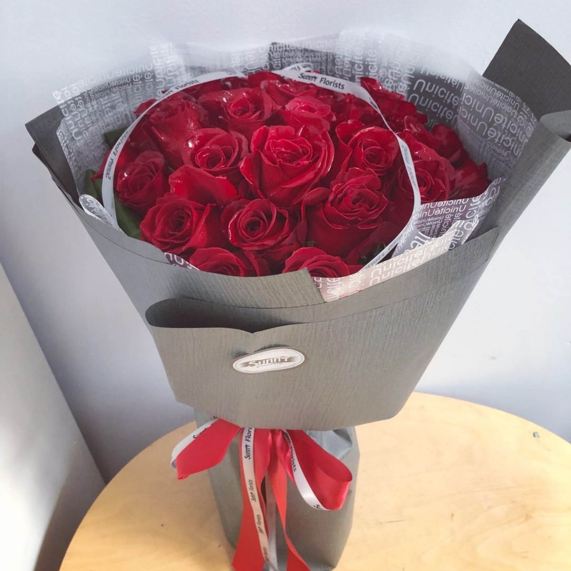 The standard size bouquet includes 2 dozen premium red roses. The deluxe