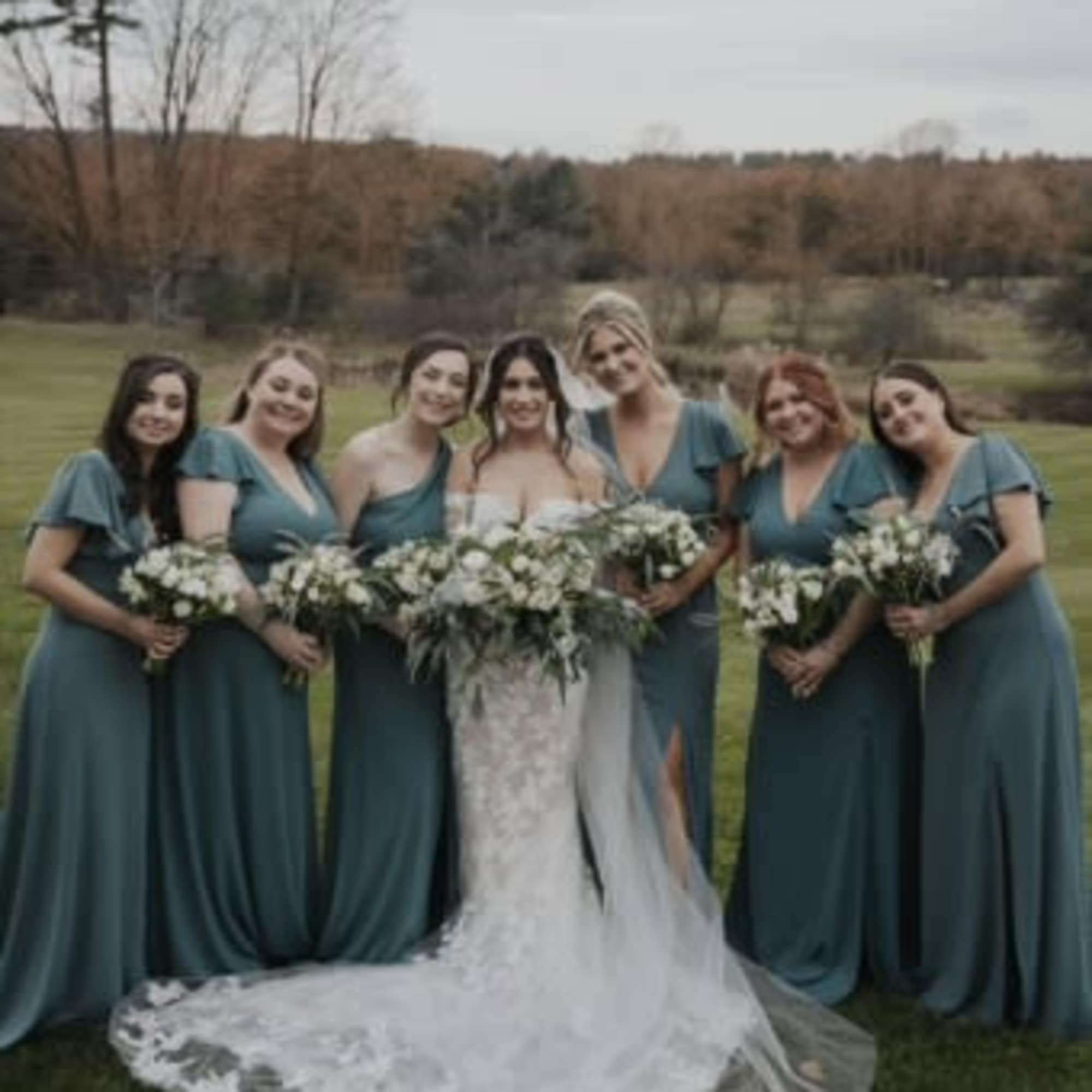 A sophisticated all-white bridal bouquet with a garden-inspired design, blending fullness and