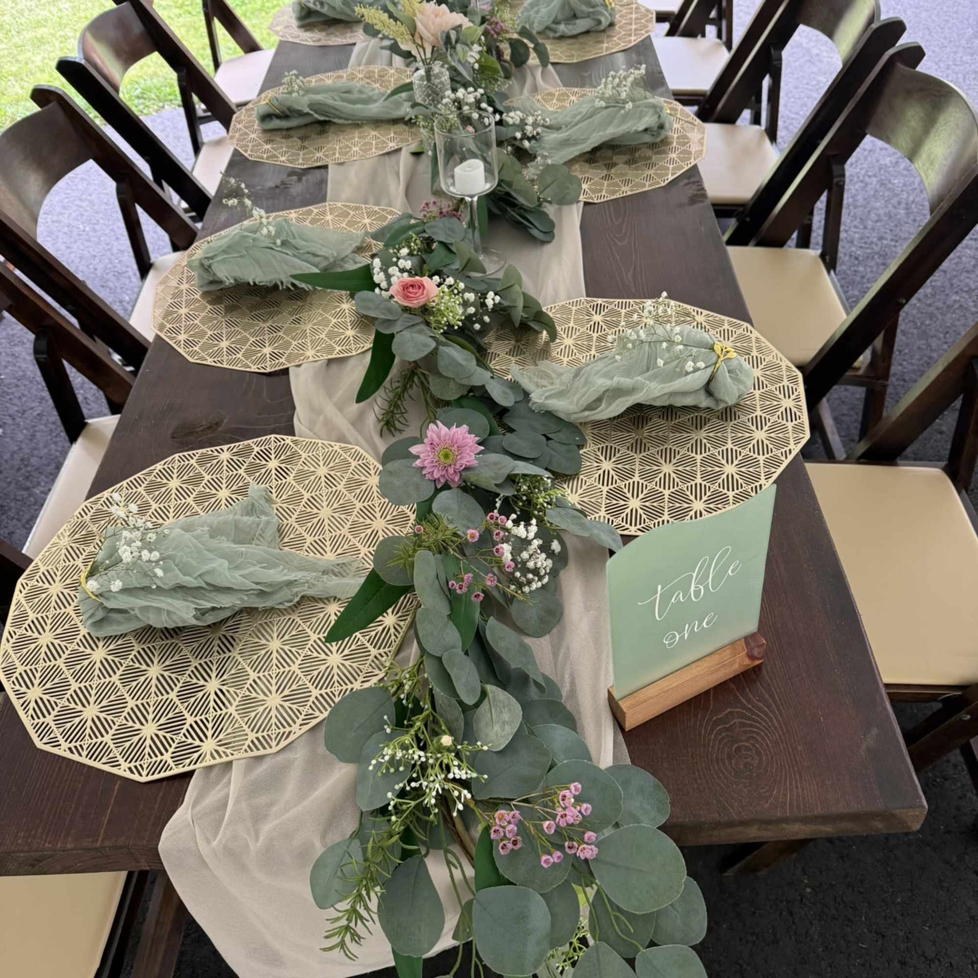 A collection of garden-style bud vases filled with delicate blooms and natural