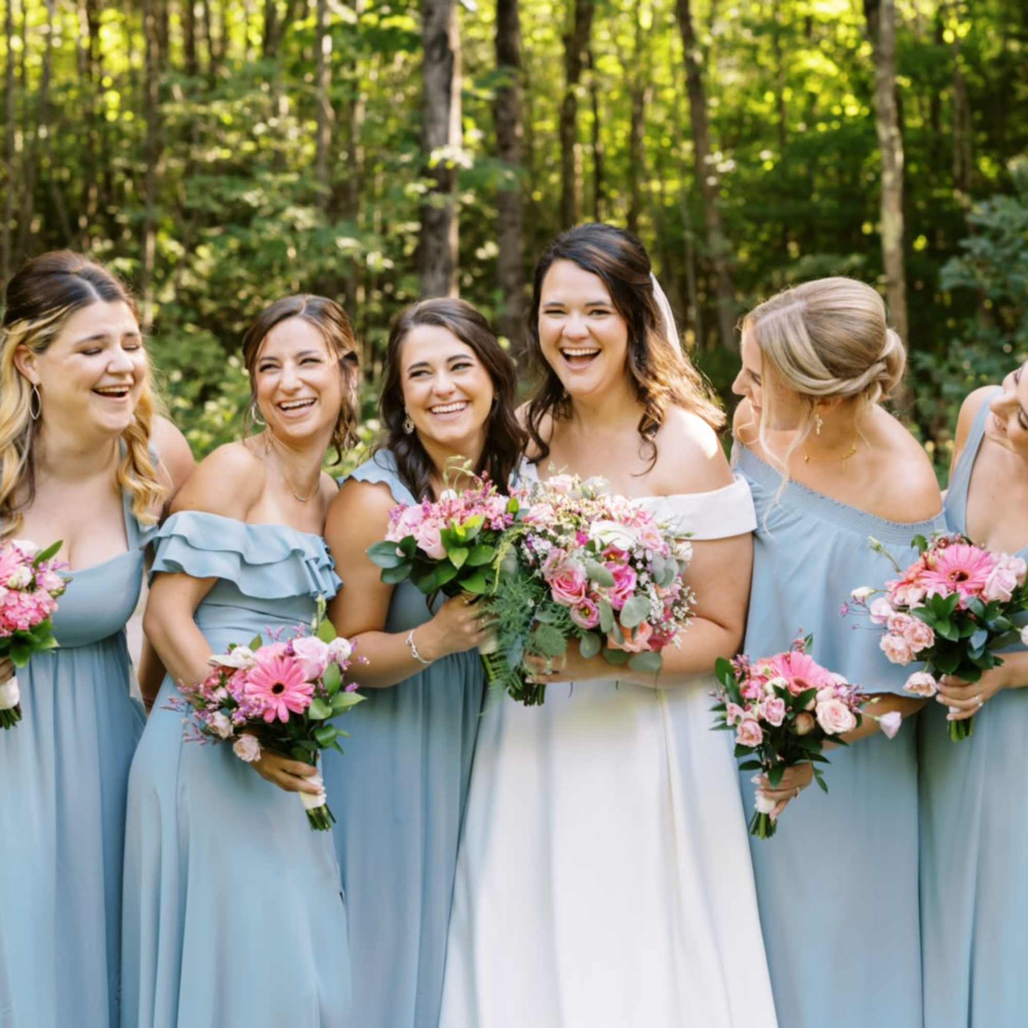 A classic bouquet of white flowers gently touched with blush pink, designed