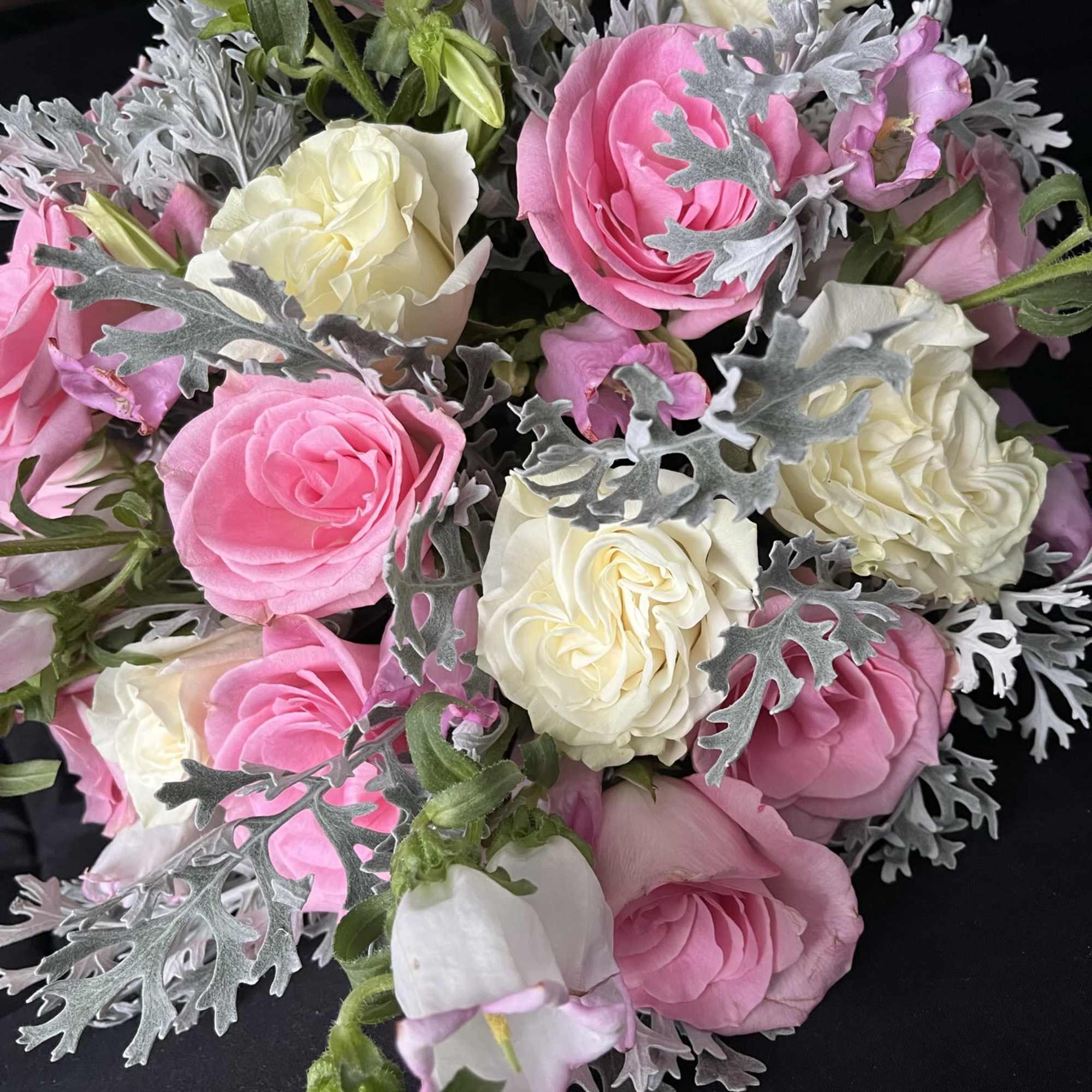 A lush garden-style bridal bouquet featuring delicate blush pink blooms blended with
