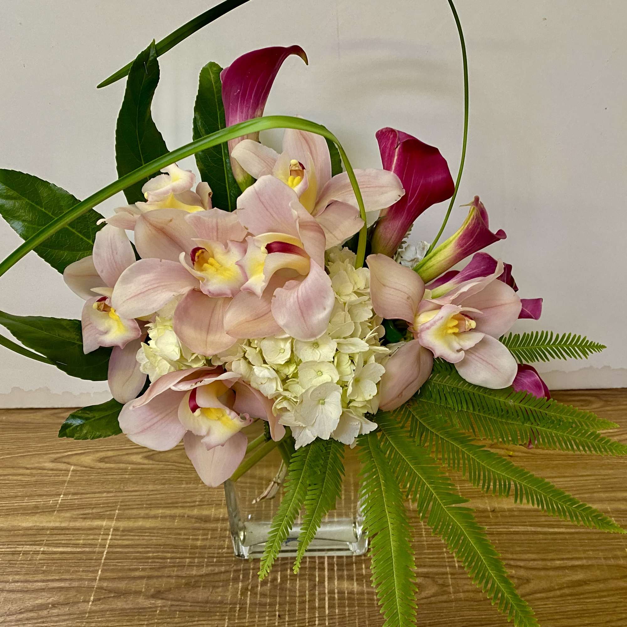 in a glass vase combination of white and green flowers