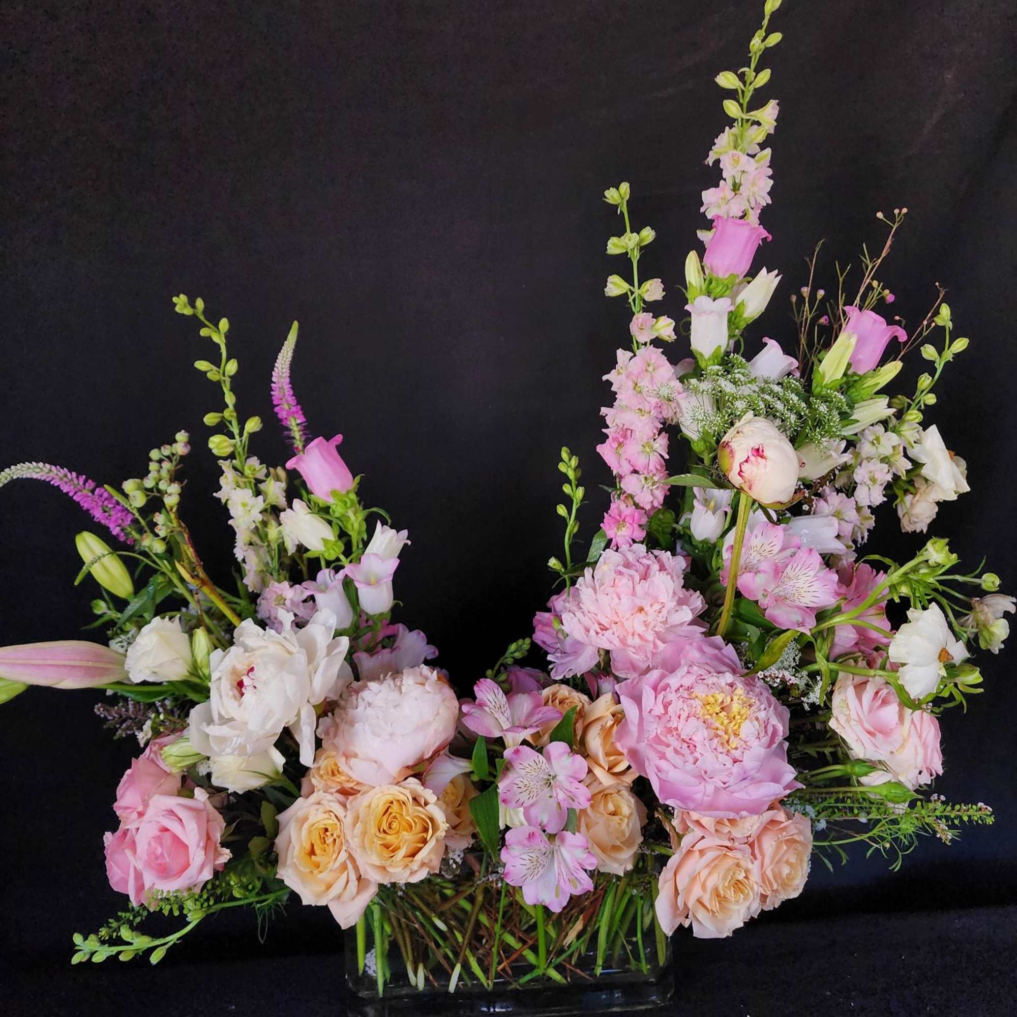 Arrangements will be in a clear glass vase. 