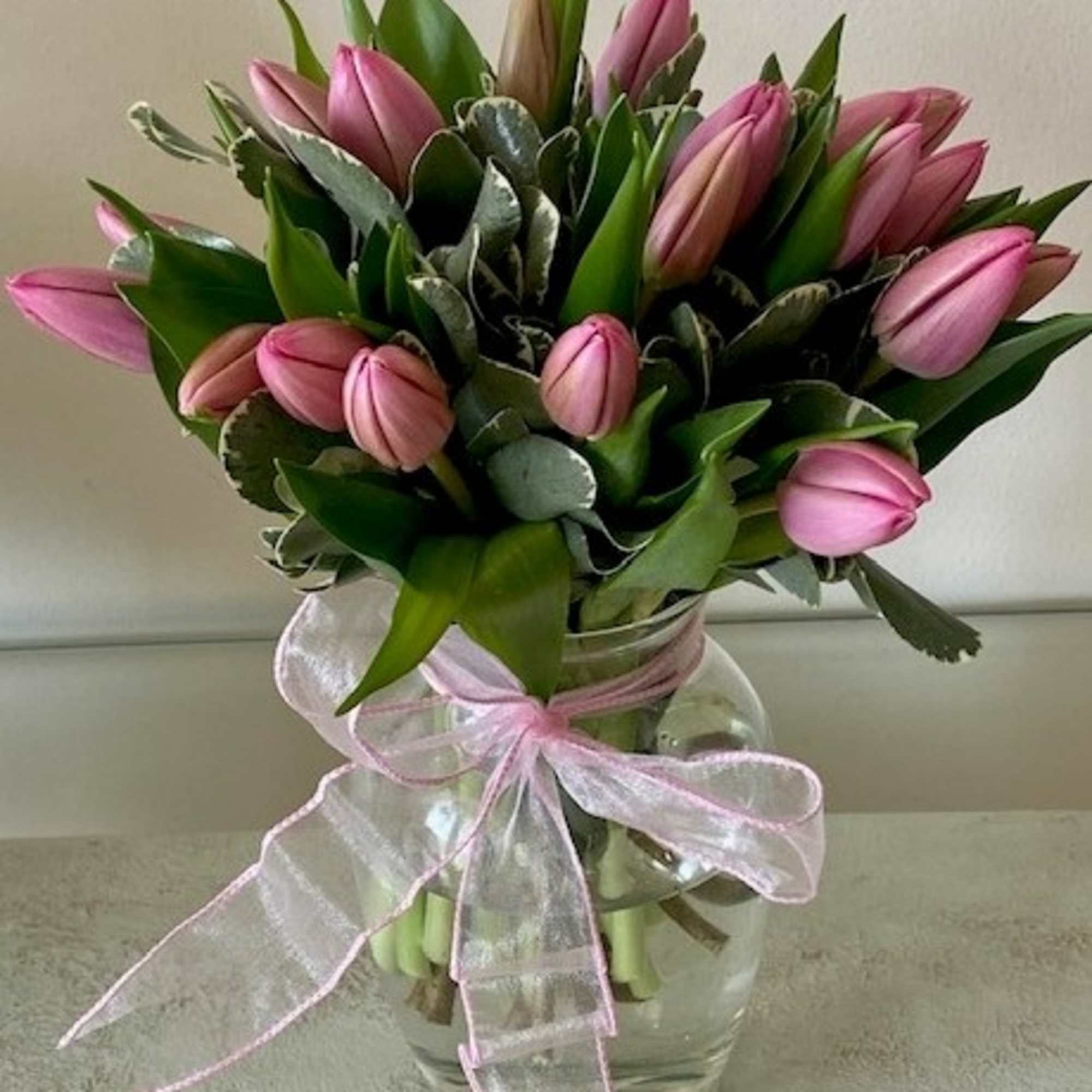 Standard as shown: 10 Pink Tulips arranged in a vase
Premium - 20