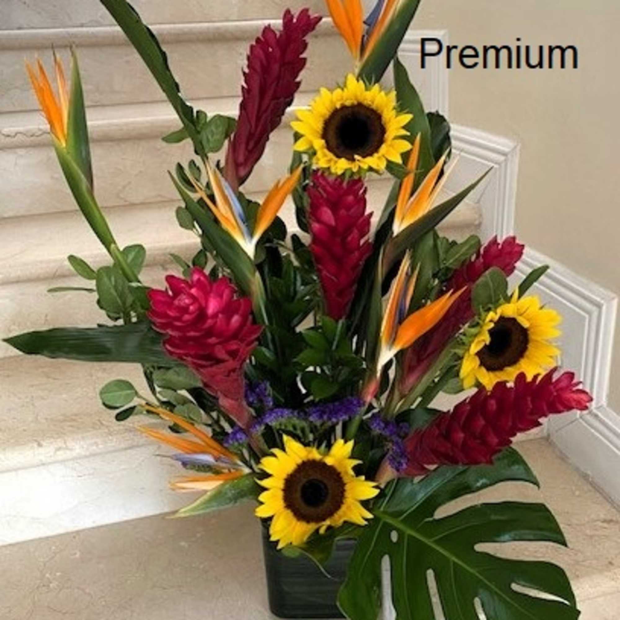 Tropical flowers as shown arranged in a vase. The quantity of flowers