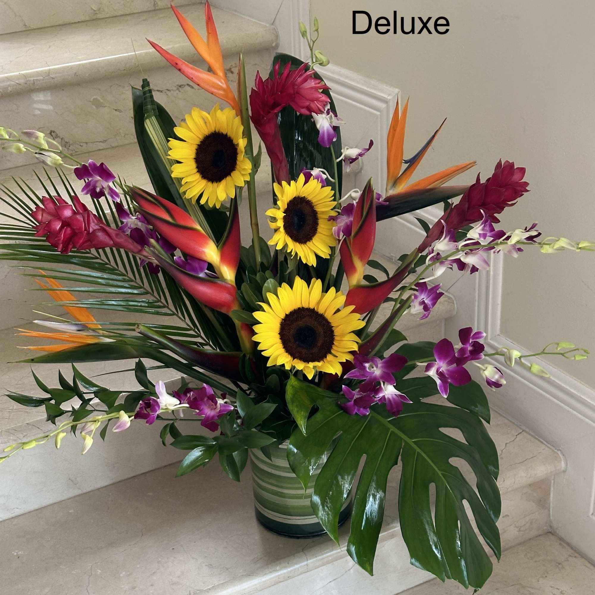 Tropical flowers as shown arranged in a vase. The quantity of flowers