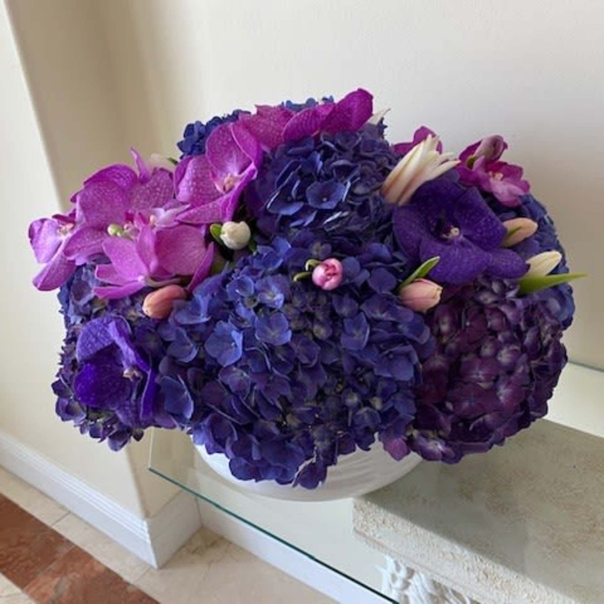 A mix of premium flowers with Hydrangas, Orchids and Tulips arranged round