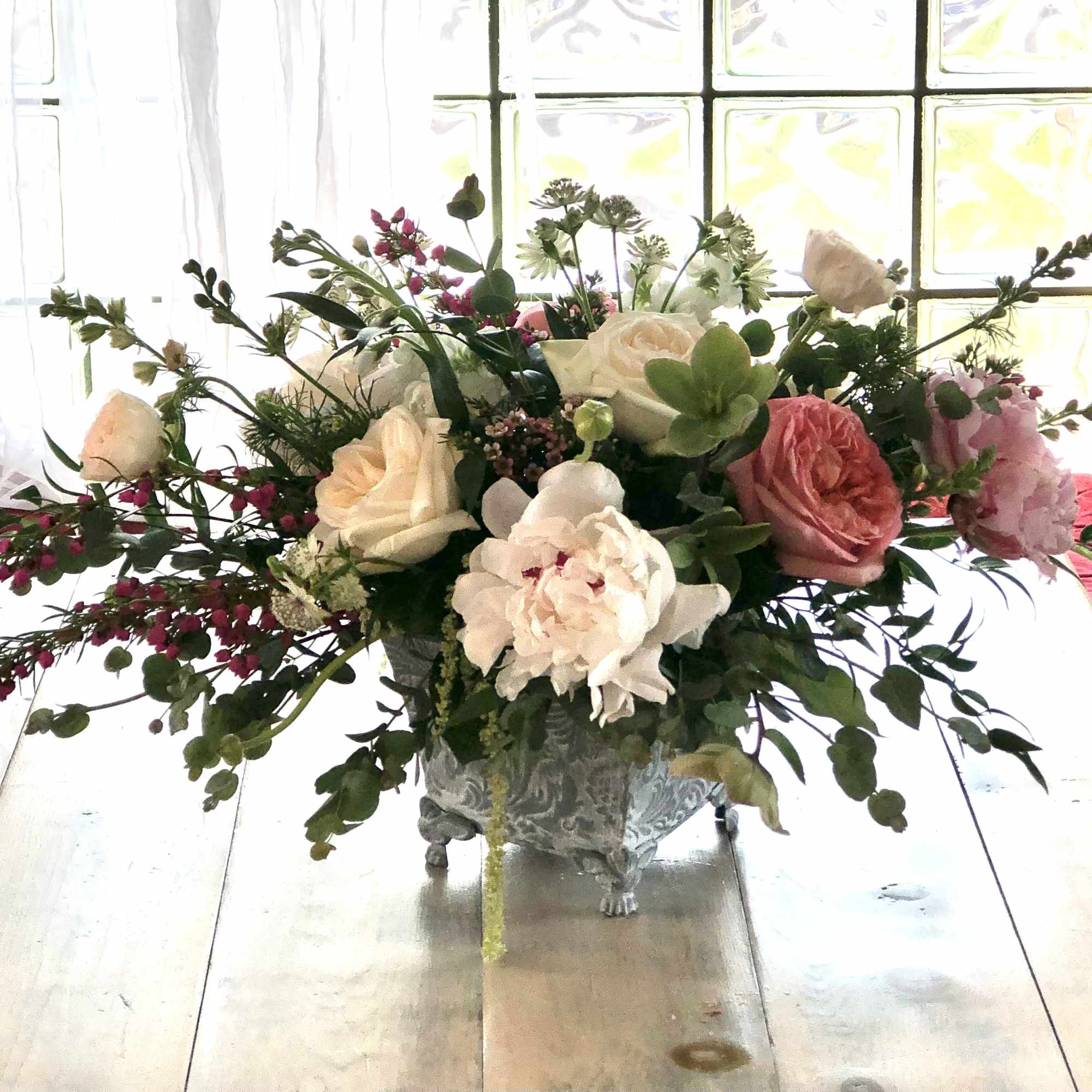 An elegant garden design with premium floral blooms, like Garden Roses, Peonies