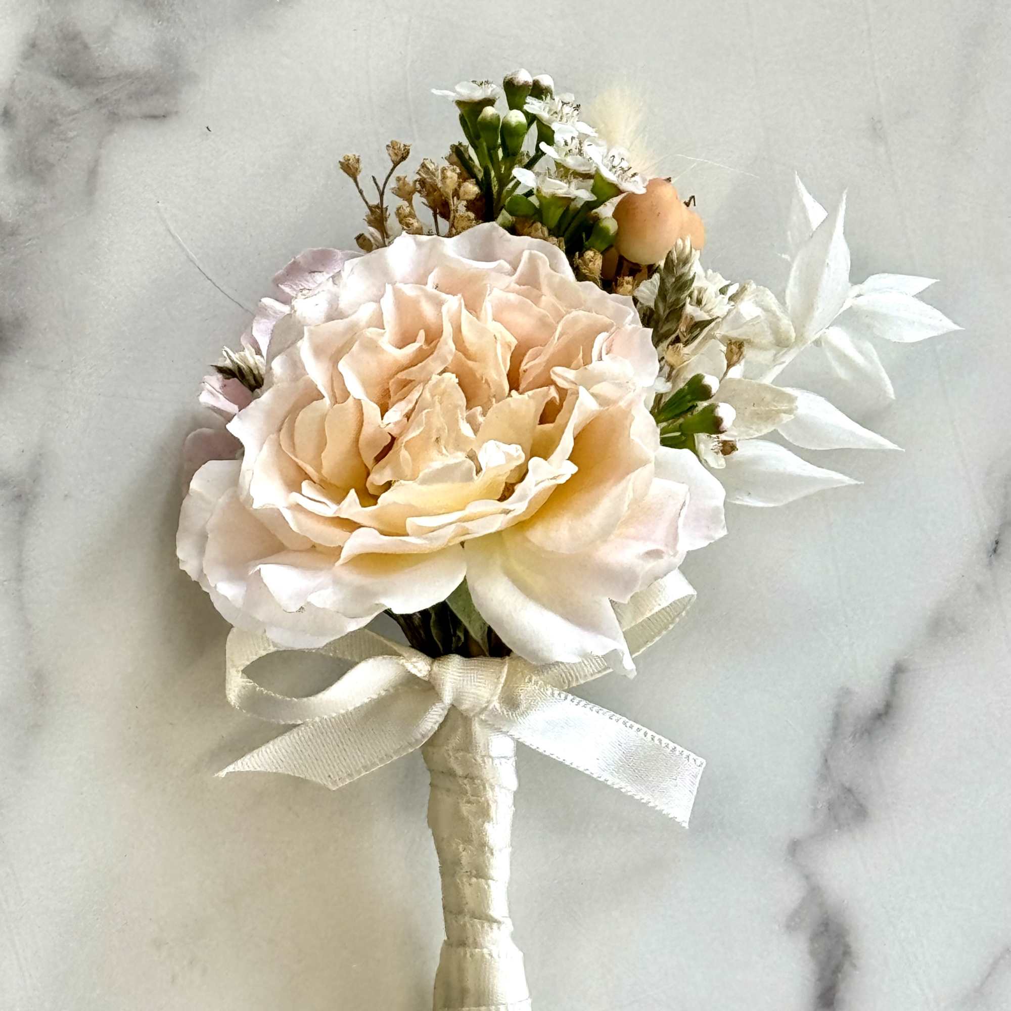 Elevate your look with this stunning corsage and boutonniere, perfect for wedding